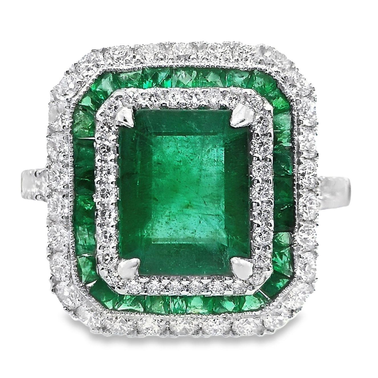 A dazzling emerald ring in 18K white gold setting, from Top Crown Jewelry collection. 
These center pieces of 2.24 carats natural emeralds have a unique intense green color, surrounded by 0.65 carats emeralds and natural sparkling white diamonds.