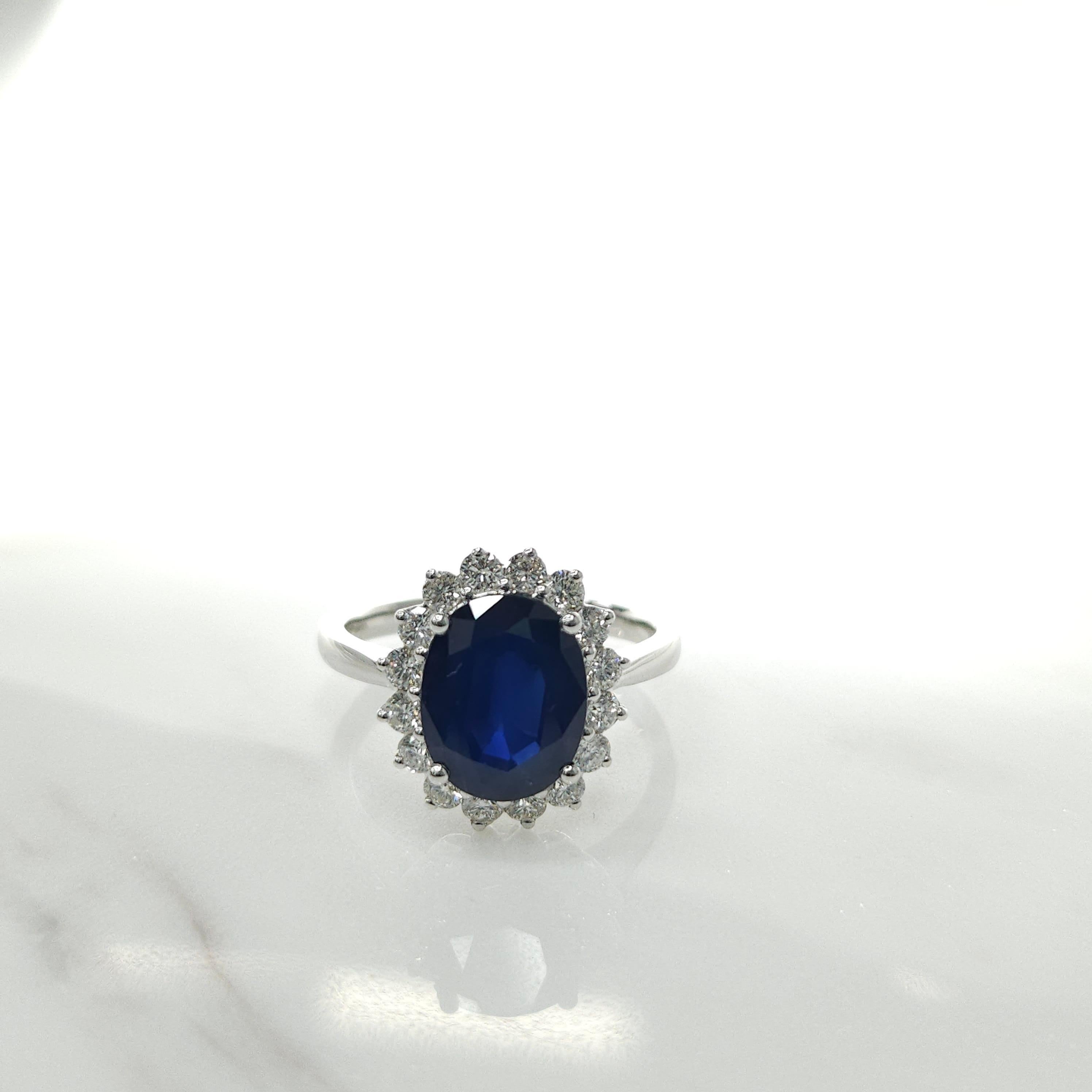 Introducing an extraordinary piece of jewelry, the IGI certified 18K white gold 2.90ct blue sapphire and 0.53ct diamond ring. This stunning ring draws inspiration from the iconic Diana ring, featuring a cluster-style design that exudes elegance and