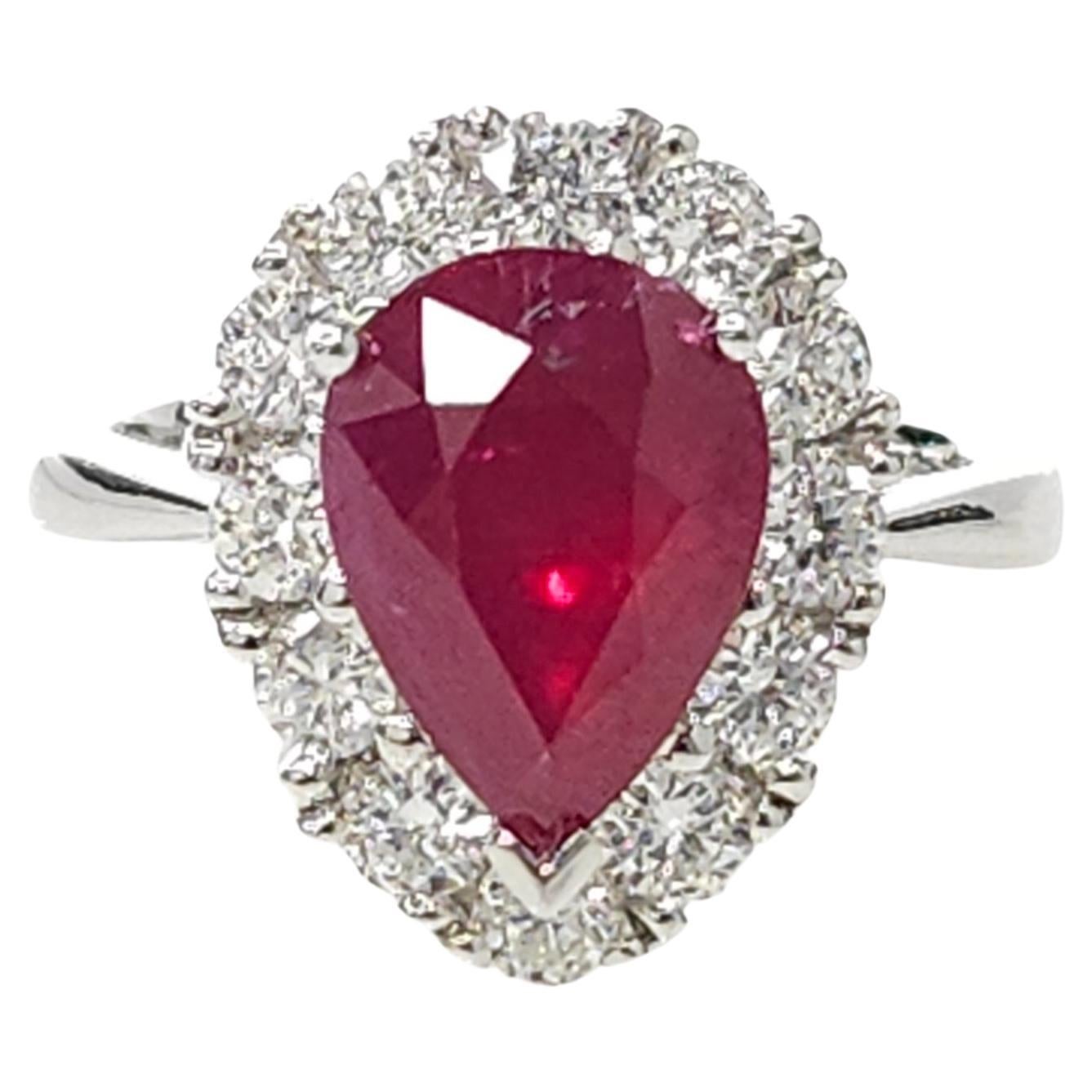 Elevate your jewelry collection with the mesmerizing beauty of this IGI Certified 3.05 Carat Pear-Shaped Ruby Ring. This exquisite piece showcases a deep purplish red ruby, certified by IGI, in a captivating pear shape that exudes opulence and