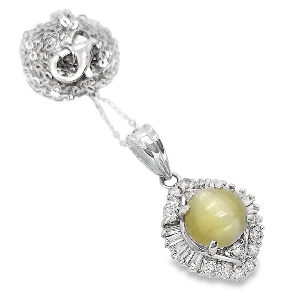 This lavish Cat's-eye round cabochon-cut center gem boasts of yellowish-green color and has semi-transparent look. 
Adorn by sparkling round brilliant and tapered baguette cut diamonds, this unique effect pendant has a timeless appeal.
This jewelry