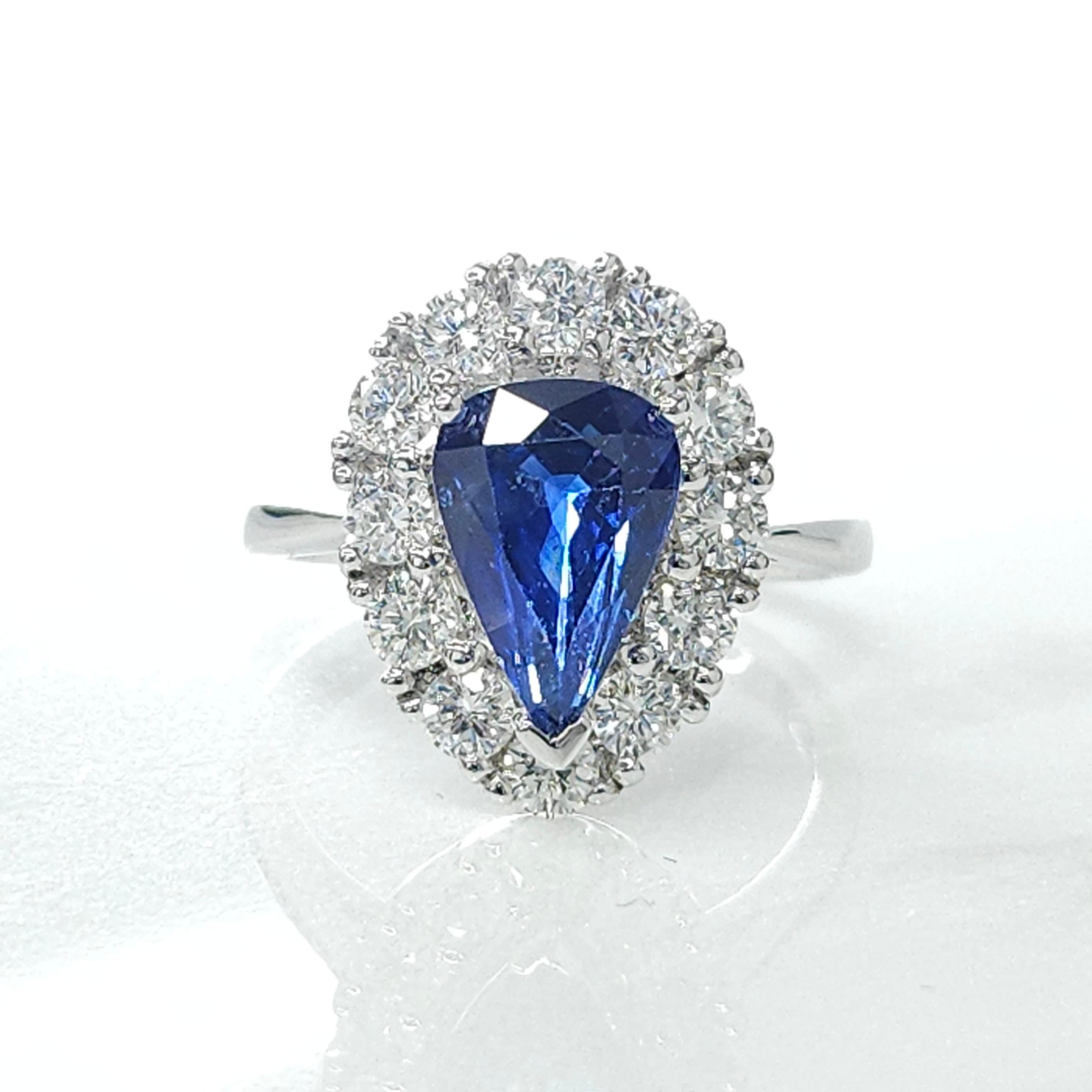 Presenting a stunning piece of jewelry featuring an IGI Certified 3.08 Carat Sapphire in a striking vivid violetish blue color. This captivating gemstone, with an elegant pear shape, takes center stage in a simple style ring crafted from 18K White