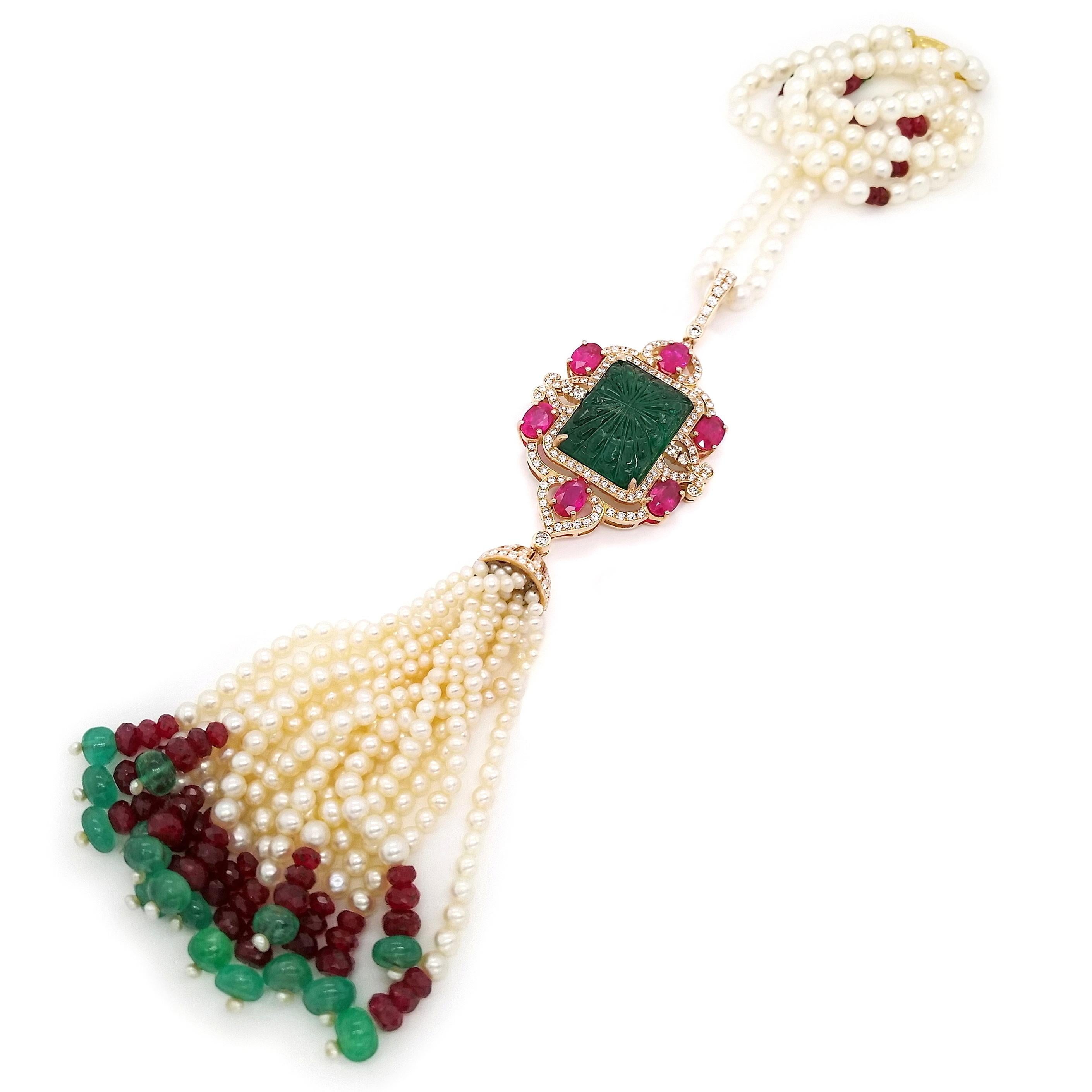 Experience true magnificence with this extraordinary 50cm necklace, set in an 18K pink and yellow gold masterpiece. A 16-carats rectangular intense bluish-green emerald takes centre stage, surrounded by oval rubies in vivid pink-red, 414