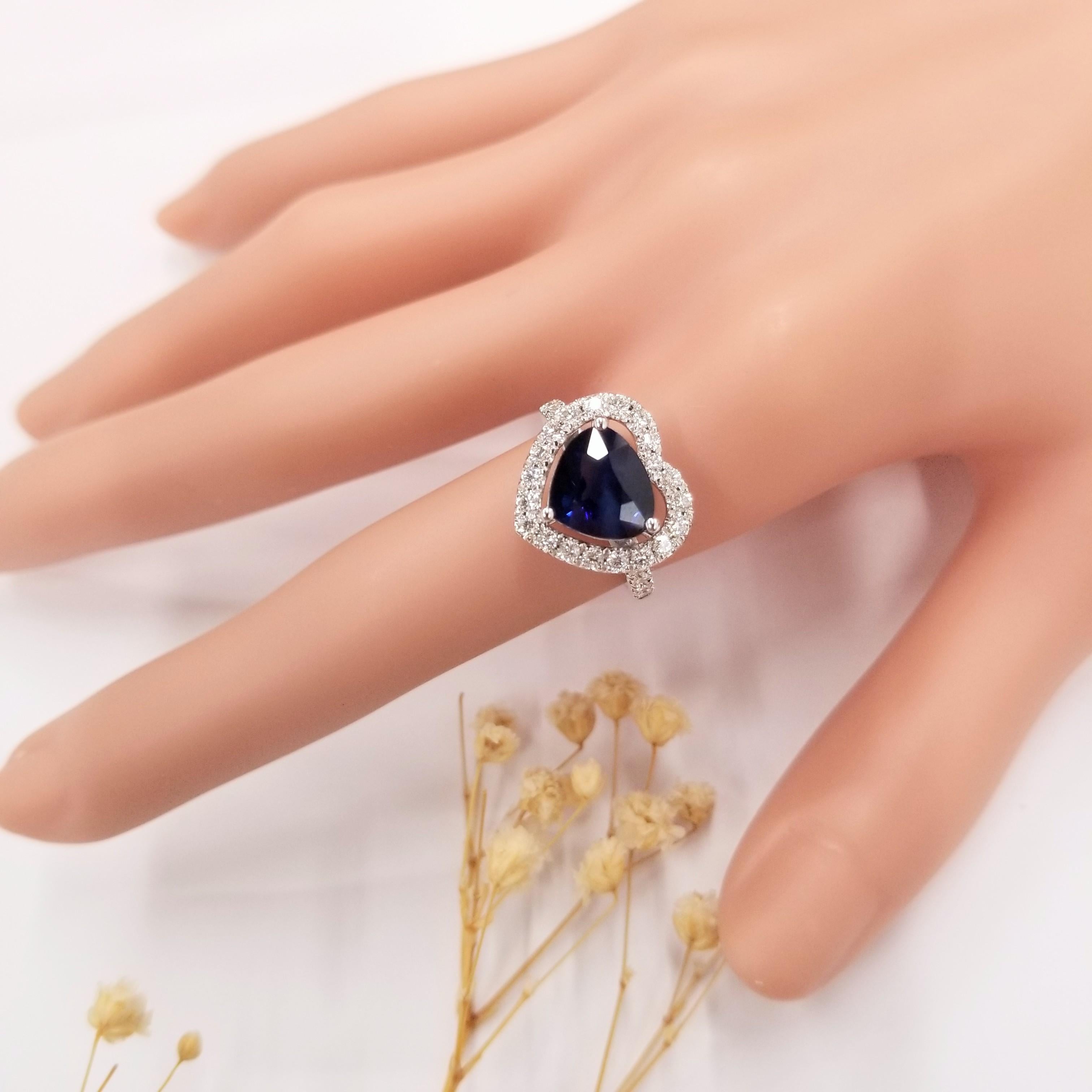 Introducing a magnificent piece of jewelry, this IGI certified ring is a true epitome of elegance and beauty. Crafted in 18K white gold, it features a stunning 3.15 carat intense blue sapphire in a captivating pear shape at its center. The intense