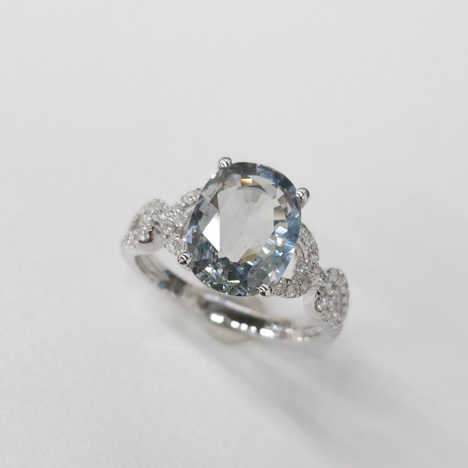 Crafted in 18K white gold, this extraordinary piece showcases a captivating  Light Green Sapphire  of exceptional quality and beauty.  It is complemented by 0.32 carats of round brilliant-cut diamonds set around the ring adding sparkle and light to