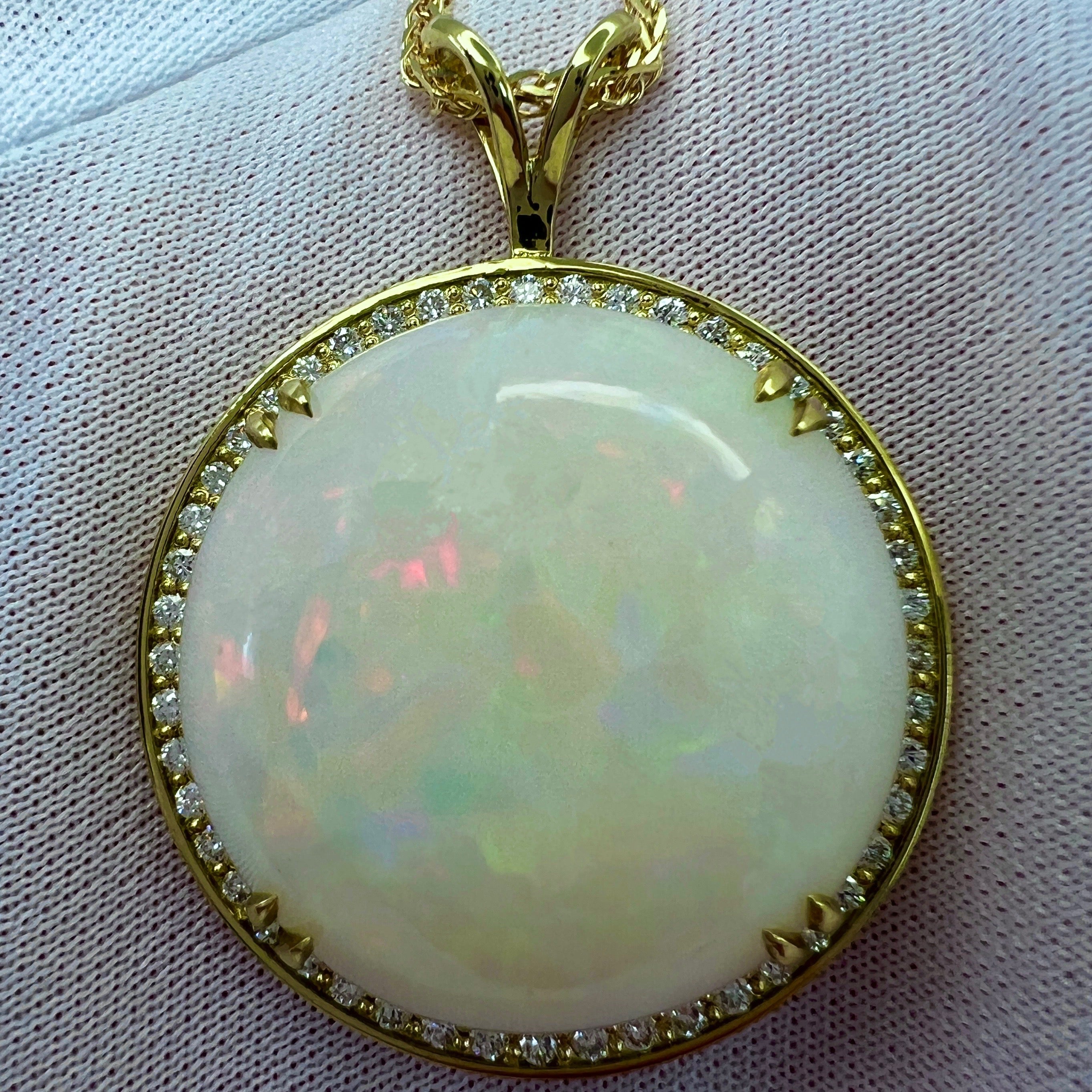 Top Grade Round Cabochon White Opal & Diamond 18k Yellow Gold Pendant Necklace.

Large 33.17 Carat opal with beautiful play of colour, lots of colour flashes. Blues, greens, oranges, yellow, purple, reds... this stone is filled with colour! 

Very