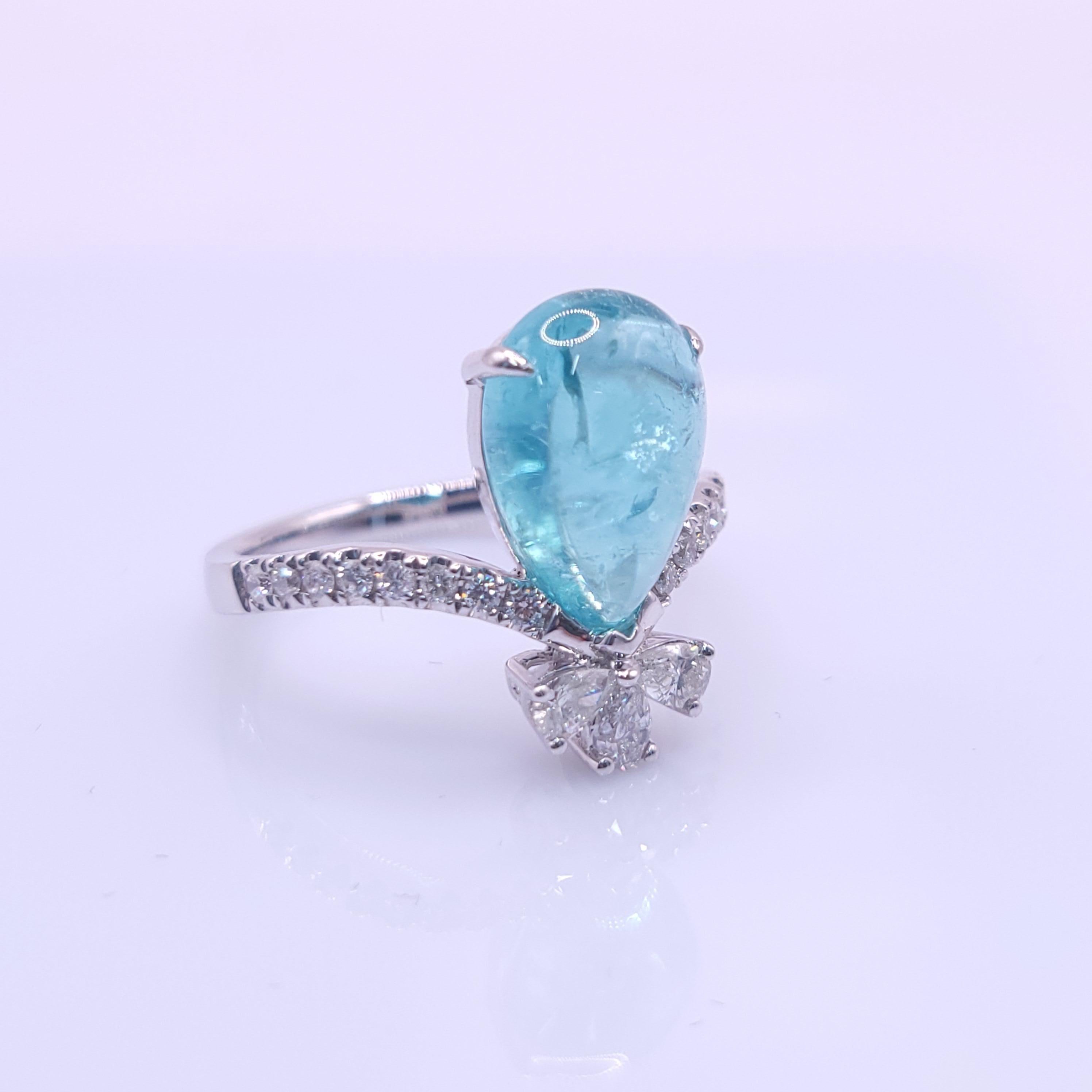 Prepare to be captivated by a truly mesmerizing piece of fine jewelry – an 18K white gold ring that showcases an exquisite IGI-certified 3.67-carat Paraiba tourmaline in a pear-shaped cabochon cut, adorned with a stunning array of diamonds.

At the