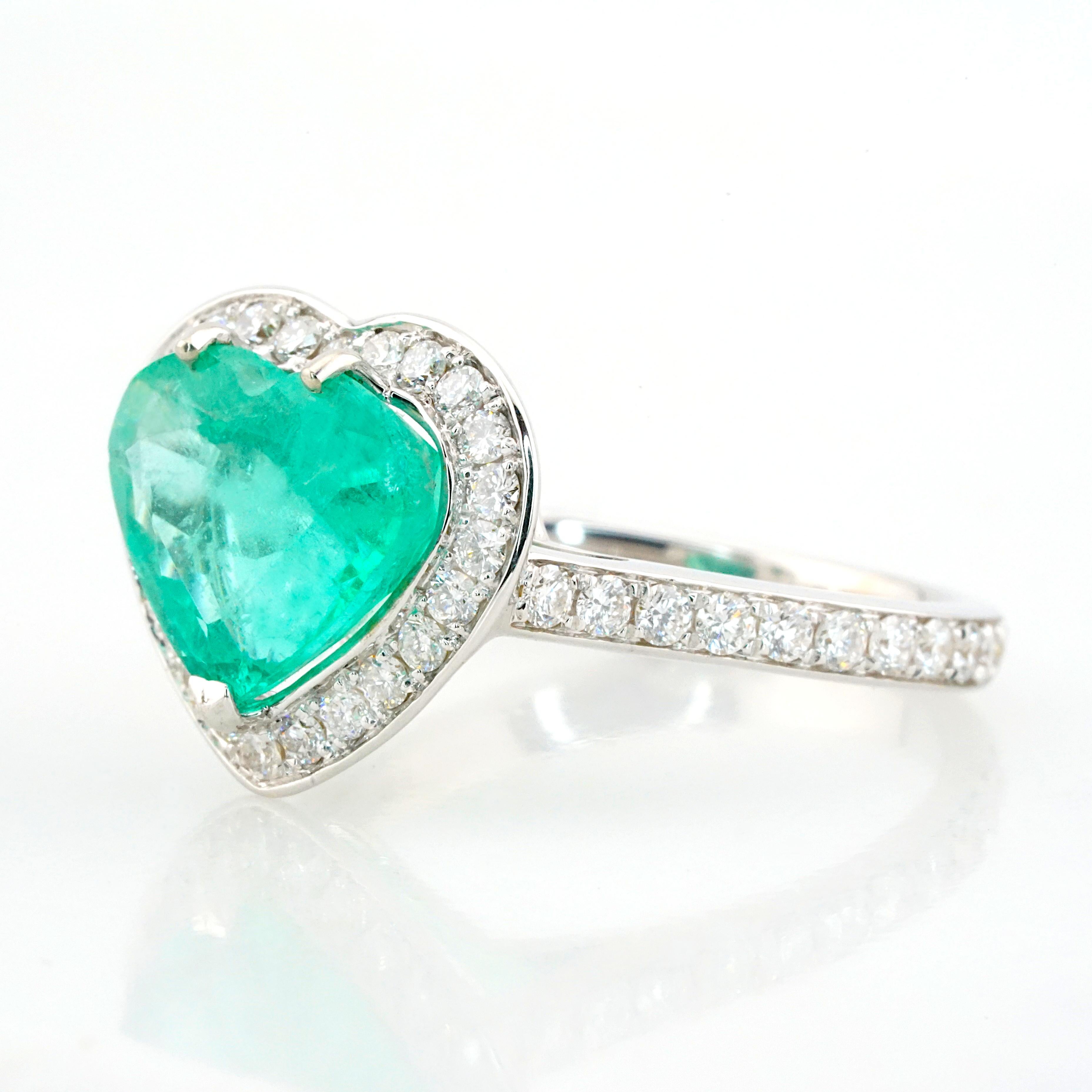 Presenting an exquisite creation from Antinori Di Sanpietro, this ring is truly a marvel to behold. At its heart lies a captivating centerpiece—a stunning 3.72-carat heart-shaped Zambian emerald, meticulously certified by the IGI Lab. Encircled by a