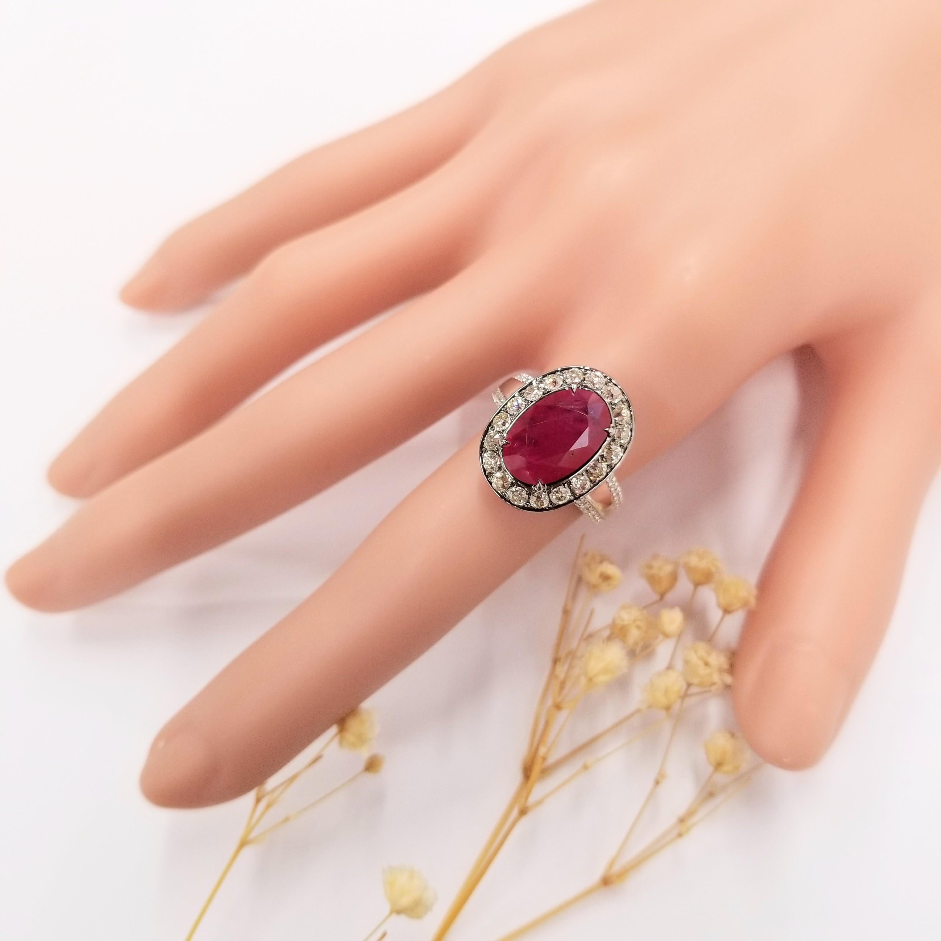 The centerpiece of this remarkable ring is a 3.73 carat deep pink-red natural ruby, exuding a captivating allure. The oval shape of the ruby adds a sense of refinement and sophistication to the design, allowing the gem to command attention from