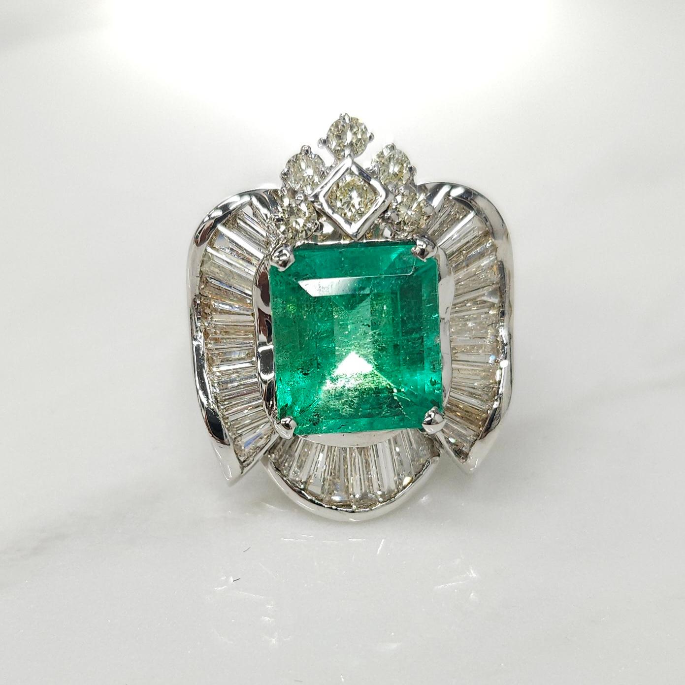 Introducing a stunning piece of jewelry that is sure to captivate and leave a lasting impression - the IGI Certified 3.92 Carat Colombian Emerald ring. This exquisite ring features an intense bluish green colored emerald, renowned for its