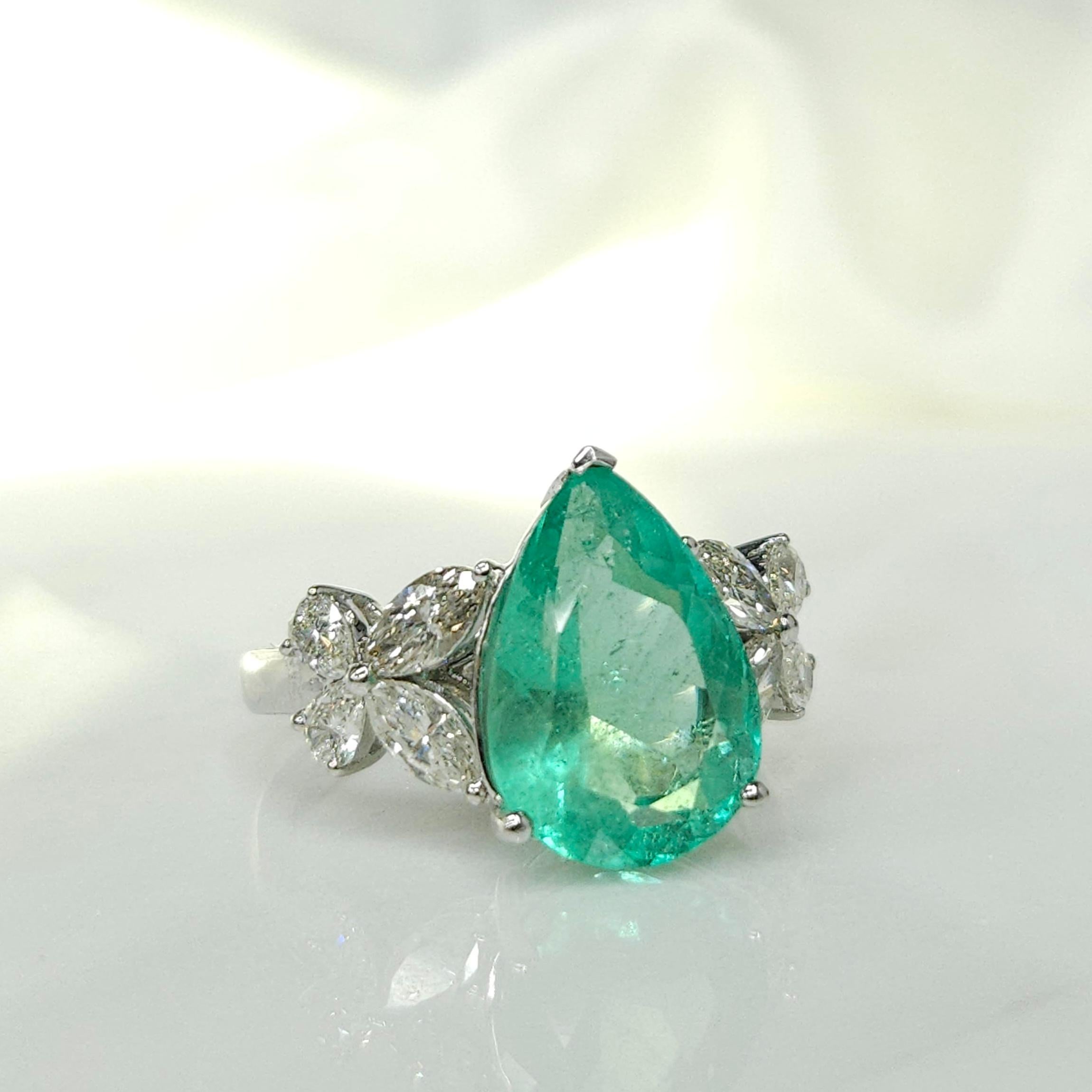 Prepare to be mesmerized by the extraordinary IGI certified 18K white gold 4.05 Carat Colombian Emerald in pear shape & 0.84ct diamond ring, a true masterpiece of fine jewelry design. This stunning piece showcases the captivating beauty of a rare