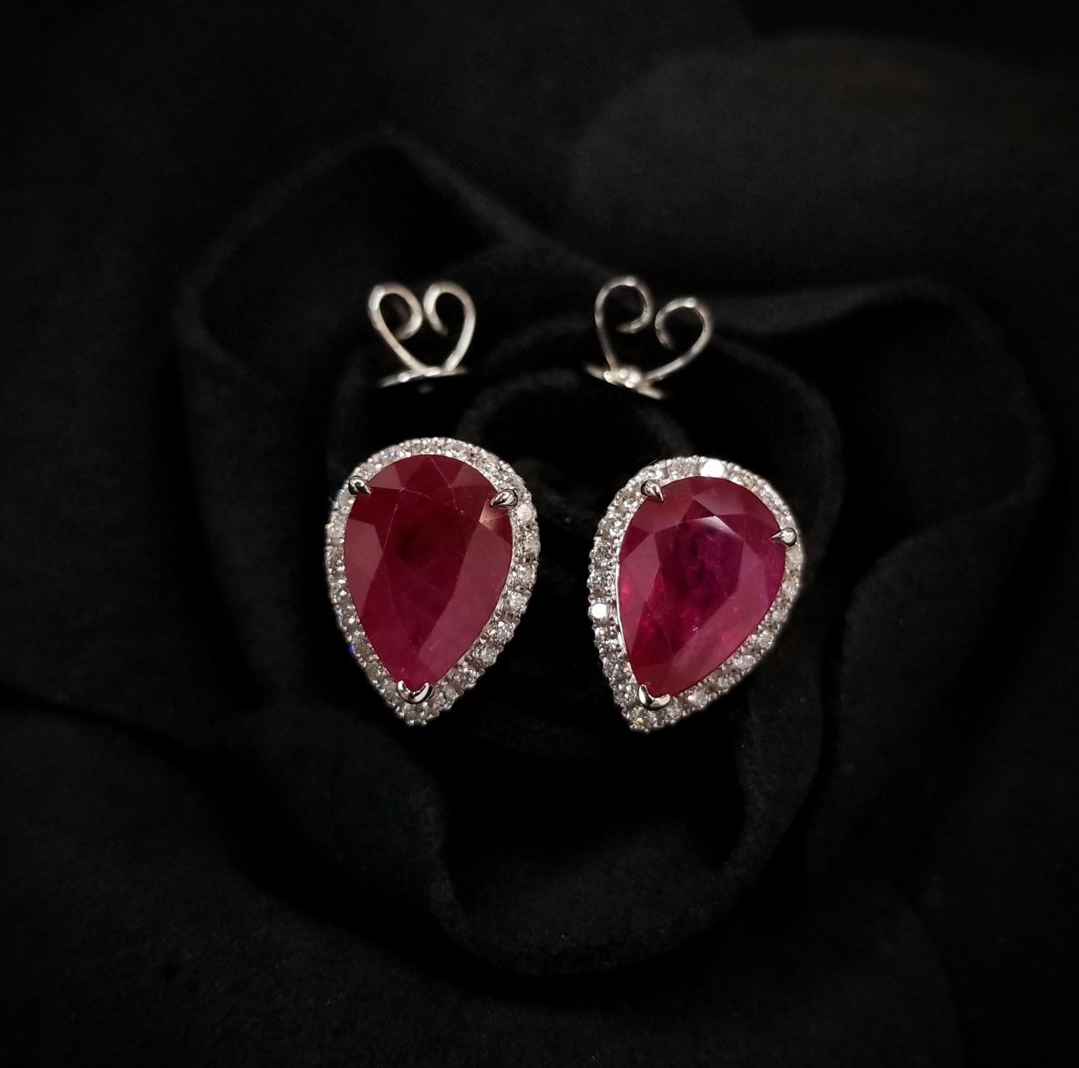 Presenting a sensational pair of earrings adorned with IGI Certified 4.10 Carat Rubies, exceptionally rare in intense purplish red color and captivating pear shape. These exquisite gemstones, known for their rarity and allure, are a true treasure to