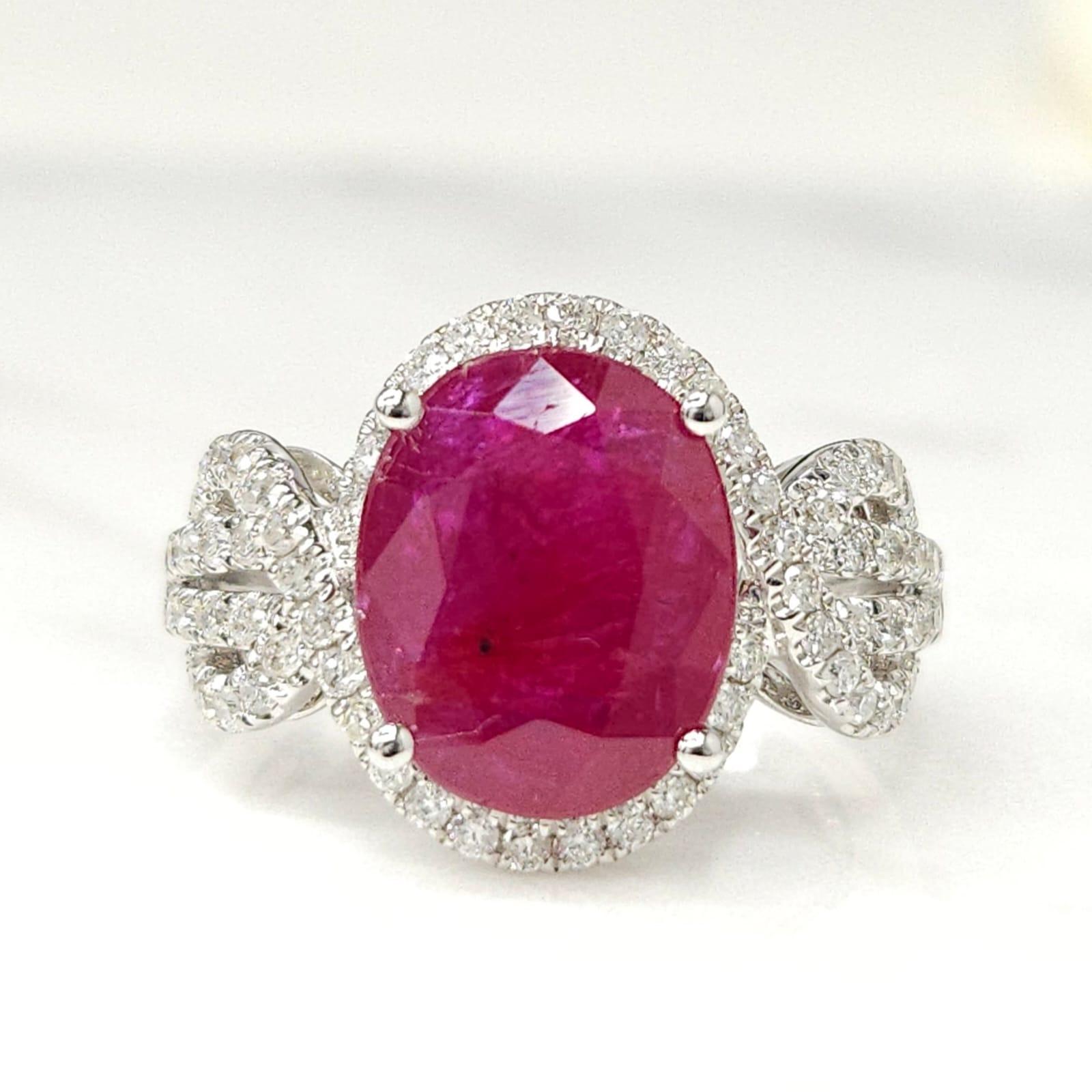 Prepare to be enchanted by this exceptional IGI Certified 4.12 Carat Ruby Ring. Crafted in luxurious 18K white gold, this exquisite ring showcases an oval-shaped Ruby of intense deep purplish-red hue, radiating elegance and allure.

The focal point