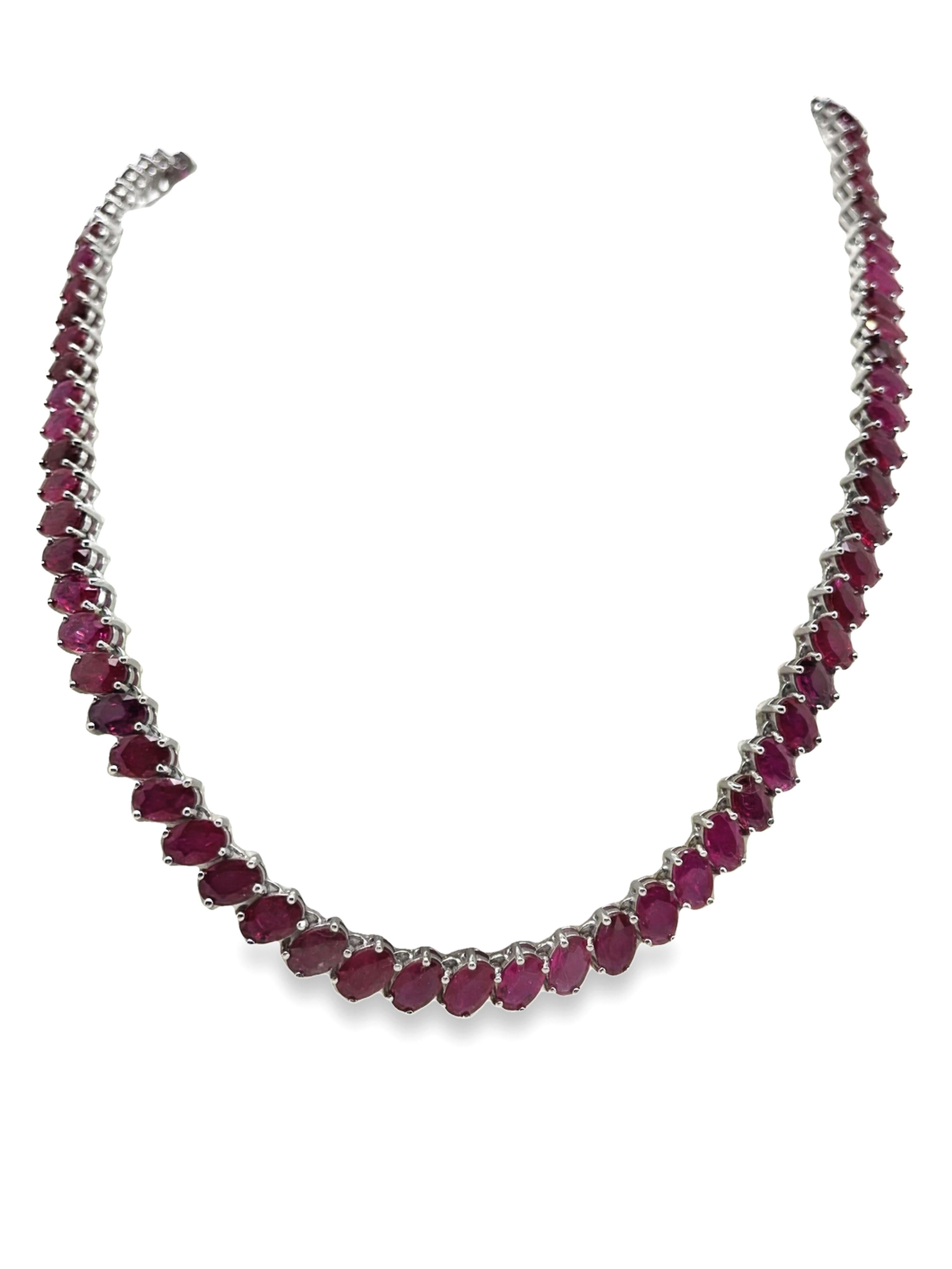 Adorn your neckline with sophistication and grace with our 41.71-carats natural rubies oval mixed cut necklace, elegantly set in 14K white gold. The timeless allure of the rubies, weighing a total of 31.45 grams, is beautifully complemented by the
