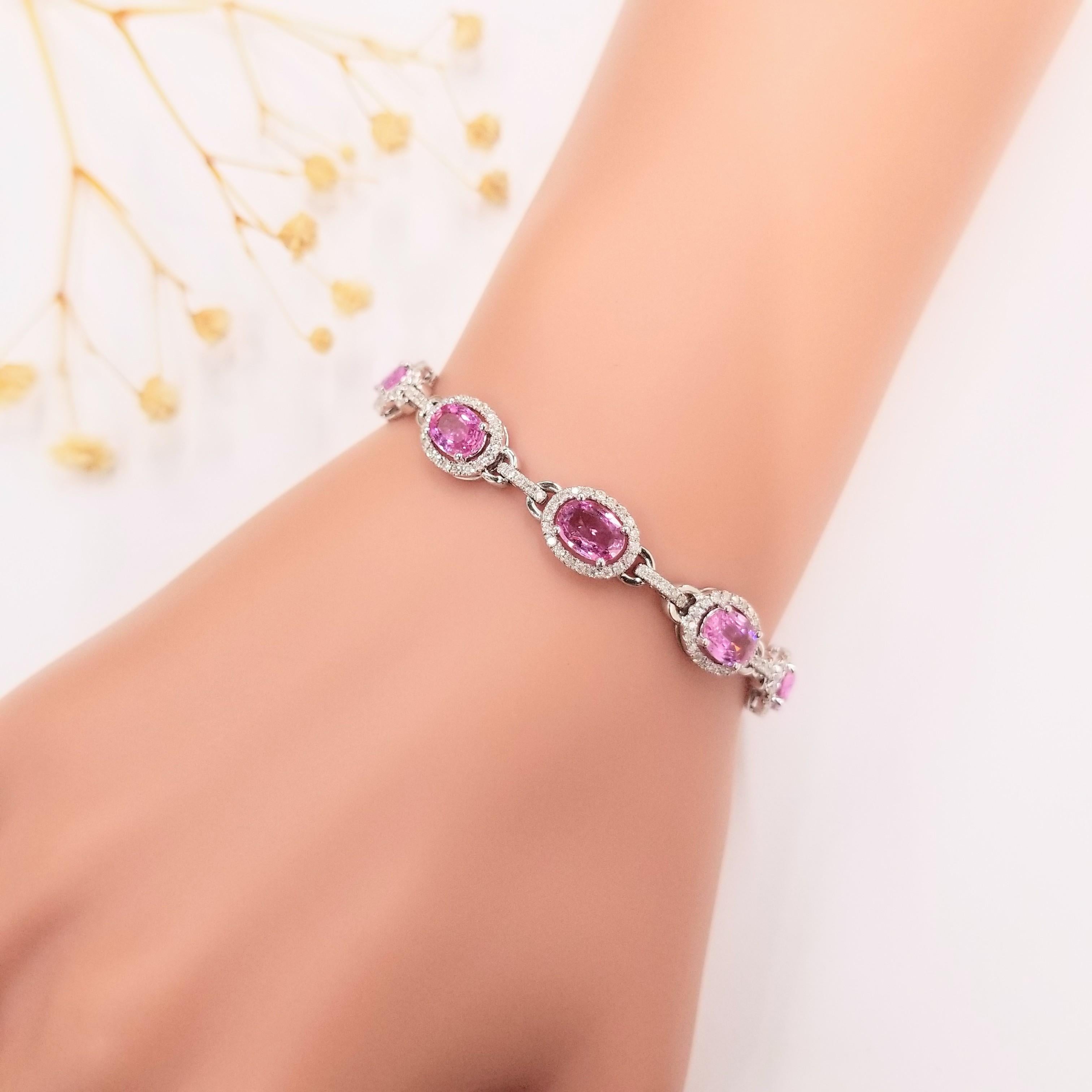 Introducing the enchanting IGI Certified 4.24Ct Pink Sapphire & Diamond Bracelet in 18K Gold. This exquisite bracelet features oval-shaped pink sapphires, showcasing a captivating intense purplish pink color. Each pink sapphire, weighing