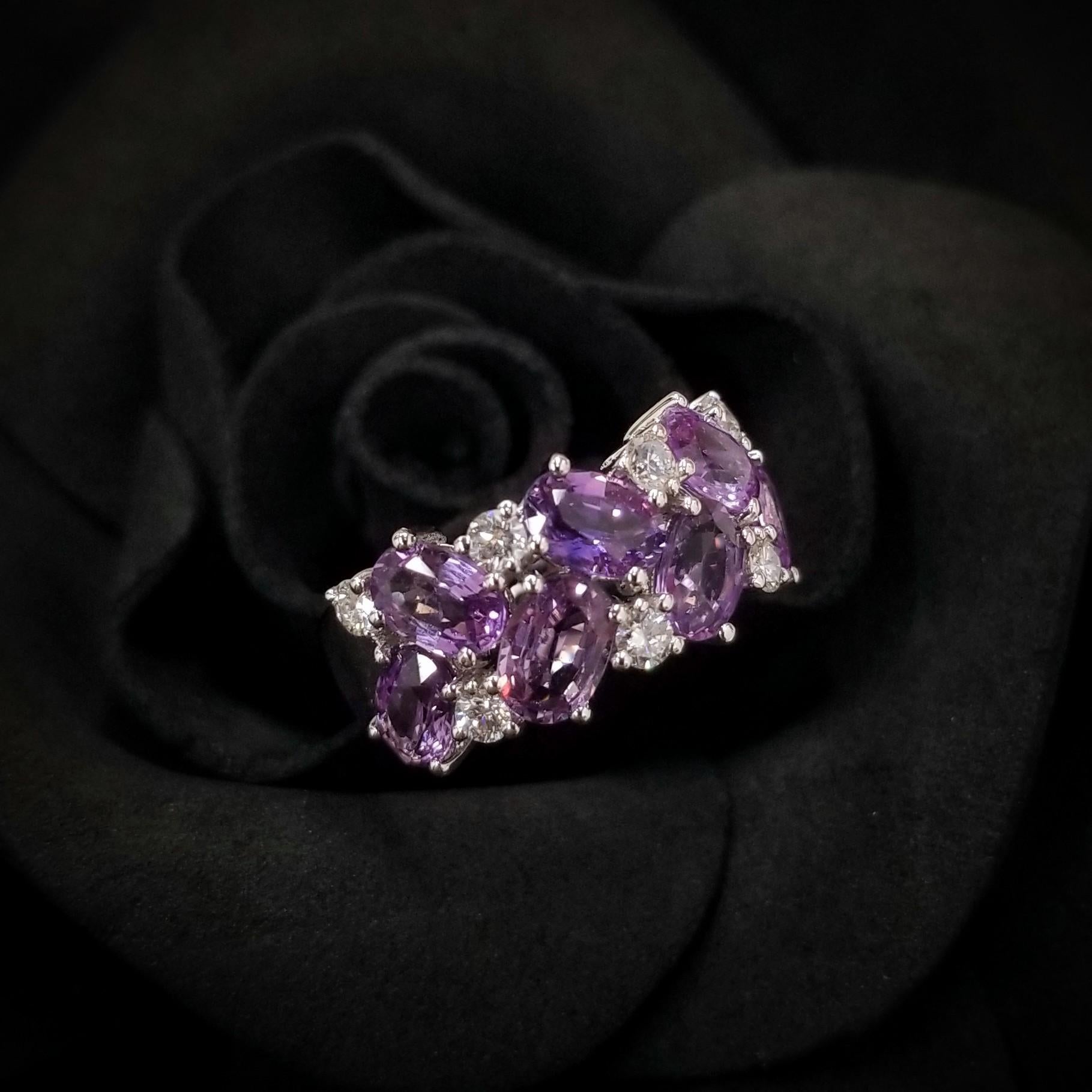 Crafted in 18K white gold, this extraordinary piece showcases a captivating 7 pieces of oval cut of purple sapphires in exceptional quality and beauty.  It is complemented by 0.37 carats of round brilliant-cut diamonds adding sparkle and light to