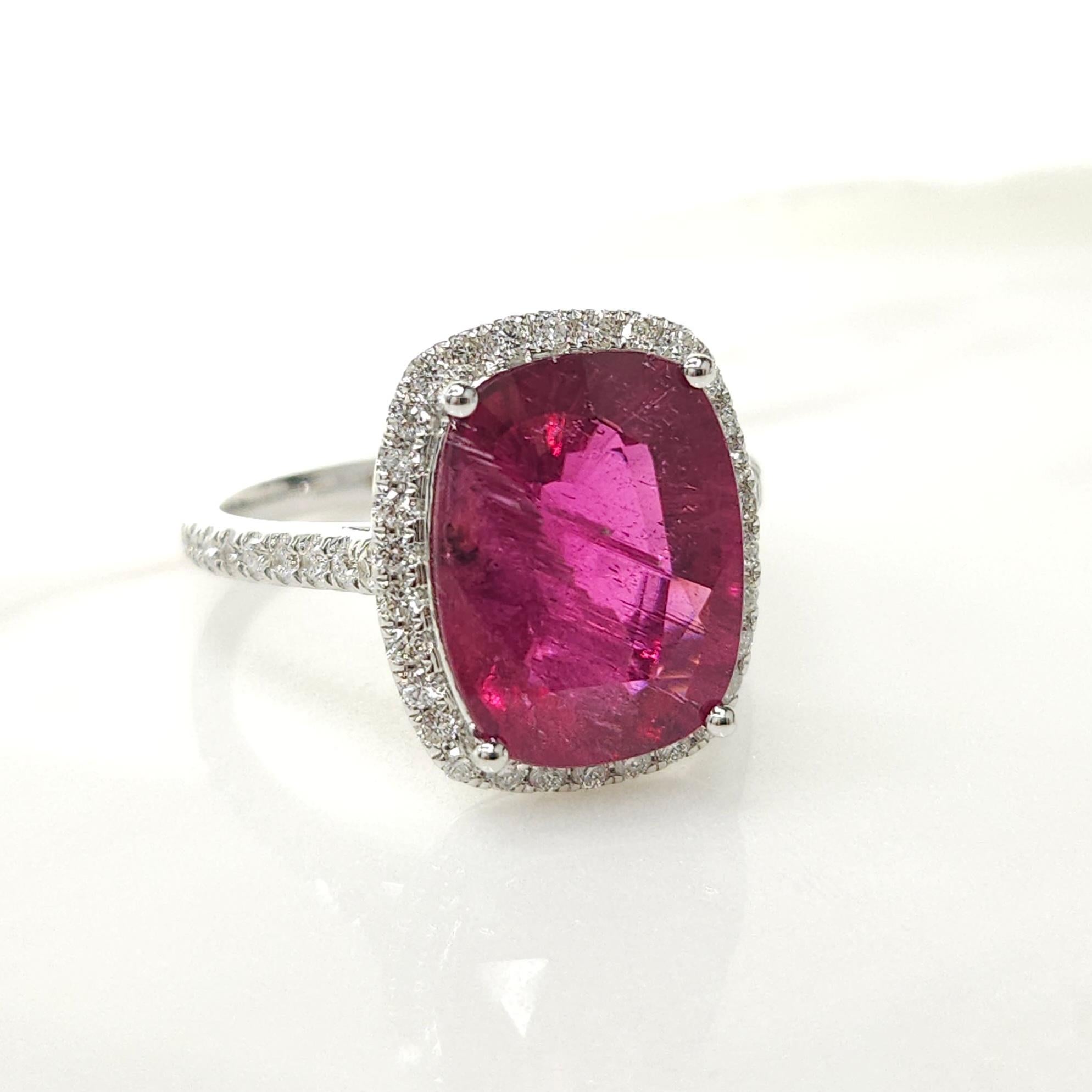 Introducing a breathtaking piece of jewelry featuring a dazzling IGI Certified  4.56 Carat Tourmaline in a striking intense purplish pink color. The cushion-shaped tourmaline takes center stage in this modern style ring crafted from 18K White Gold