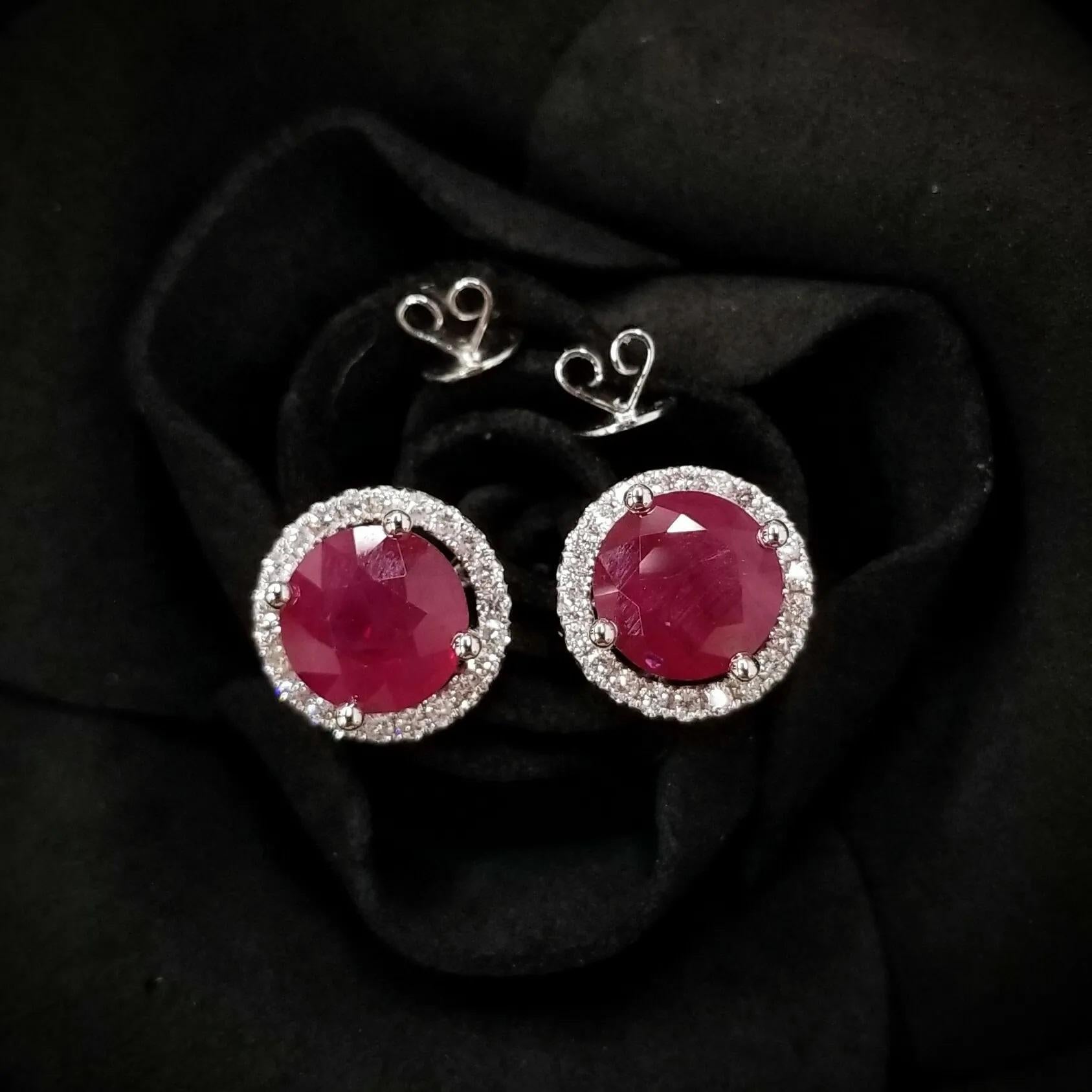 Burmese rubies are sought after for their beautiful red tones. Halo set with round brilliant-cut diamonds, the total diamond weight for the piece is 0.37 carats. 
The ruby studs can be detached from the white diamond jackets. You could either wear