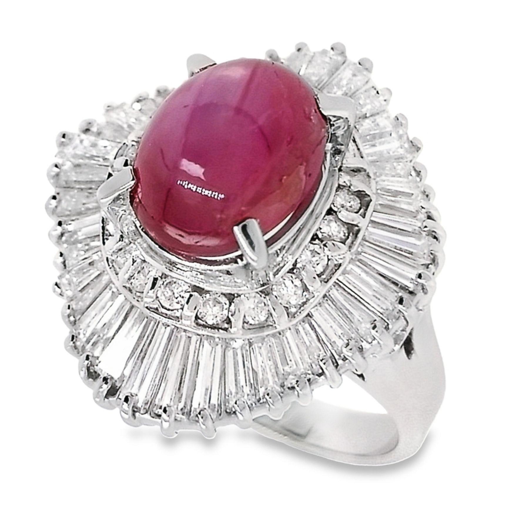Prepare to be enchanted by the sheer magnificence of this platinum ring, adorned with a breath-taking 4.80ct No-Heat Burma Star Ruby and 1.95ct Natural Diamonds, meticulously verified by an IGI Report. The oval cabochon ruby, boasting an Intense