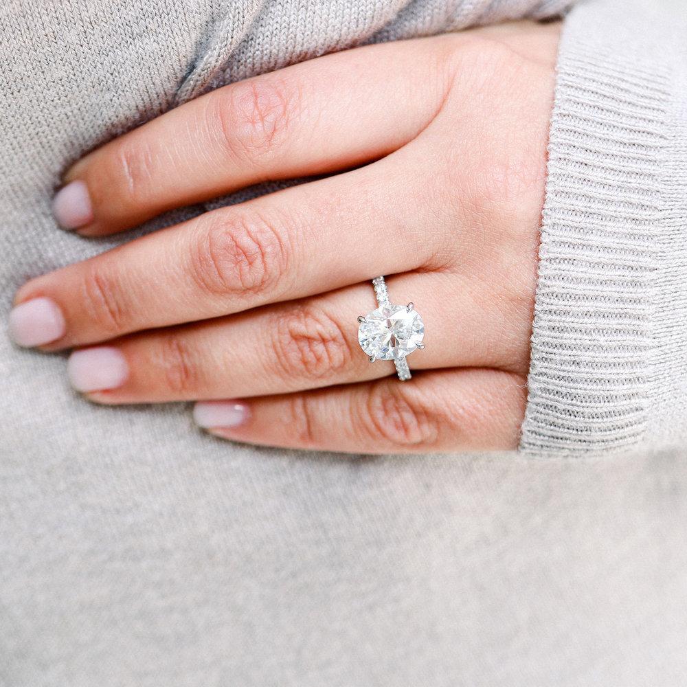 This amazing 4 carat oval cut diamond engagement ring is really a stunning piece. The delicate pavè really sets off the oval and shows how gorgeous of a stone it is. This piece comes with an GIA stating the main stone weighs 4 ct

