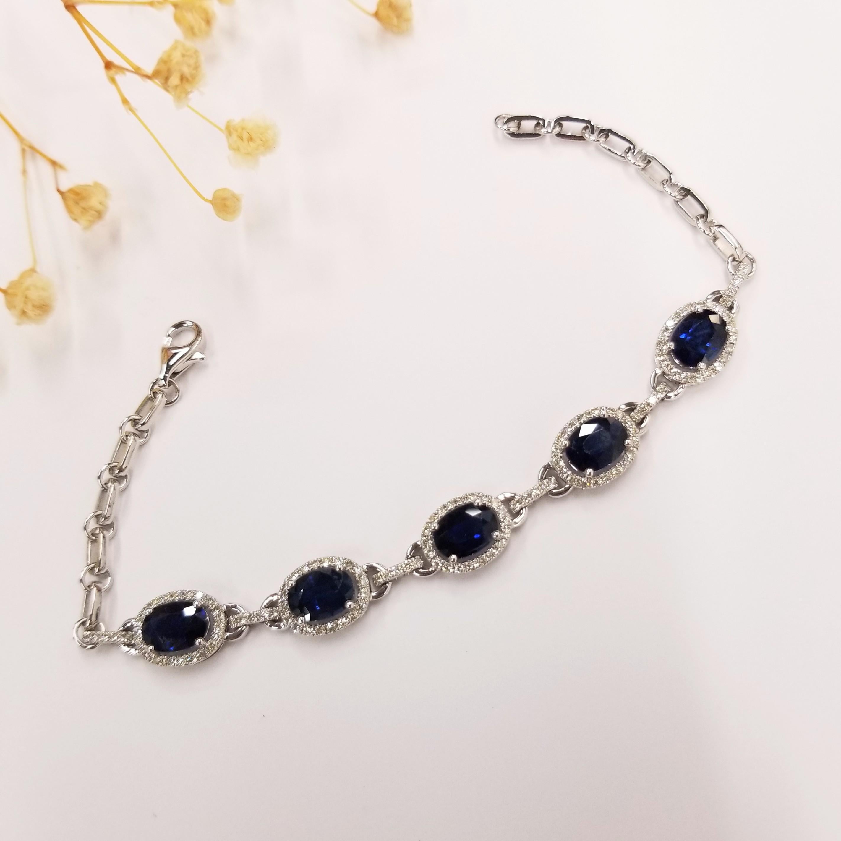 Introducing the exquisite IGI Certified 5.32Ct Blue Sapphire & Diamond Bracelet in 18K Gold, a true testament to sophistication and elegance. This stunning bracelet showcases oval-shaped pink sapphires in an intense blue hue, each weighing more than