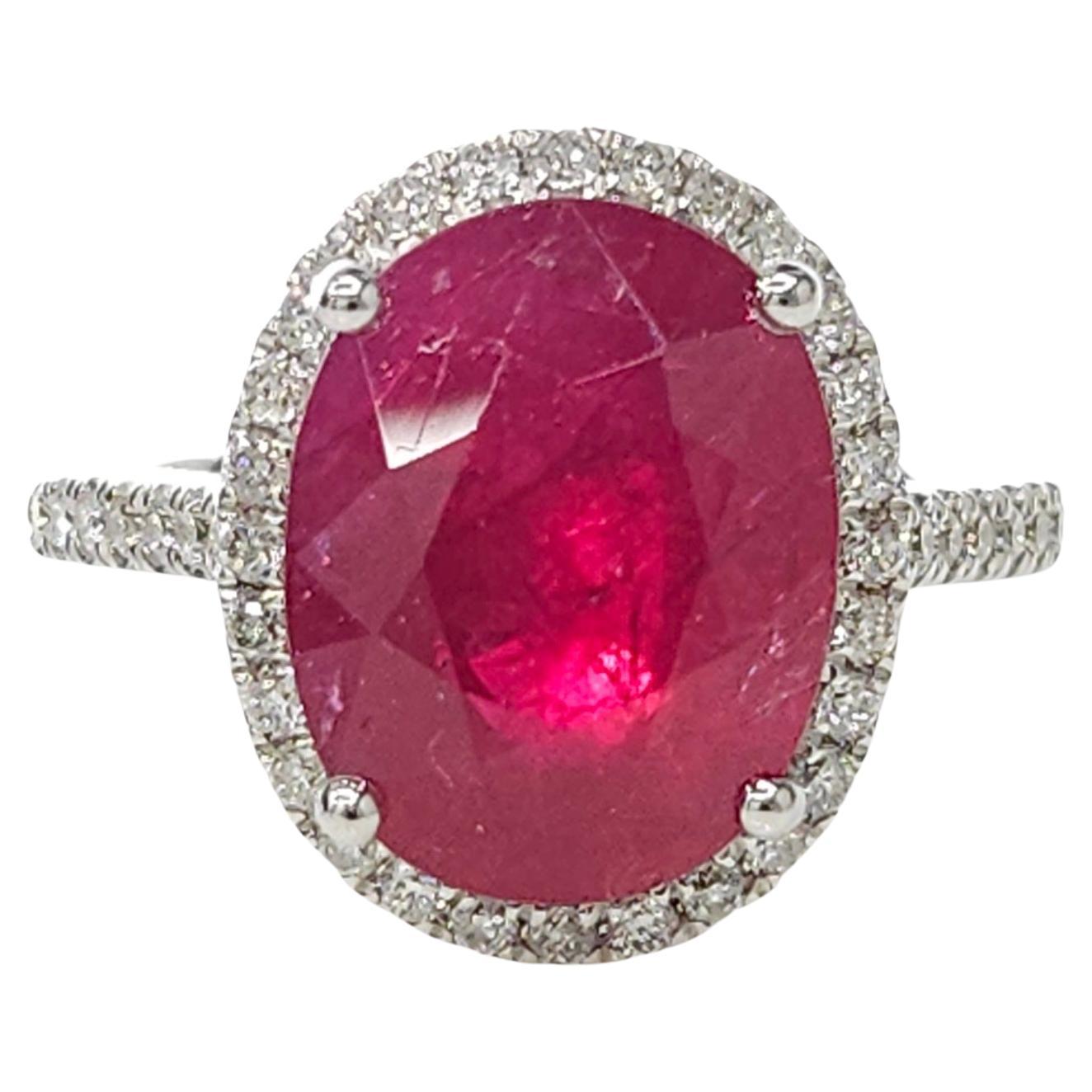 Indulge in the ultimate luxury with this IGI Certified 5.90 Carat ruby ring, an exquisite masterpiece that combines exceptional gemstones and modern design. With its deep purplish red color and oval shape, this rare and extraordinary ruby captivates