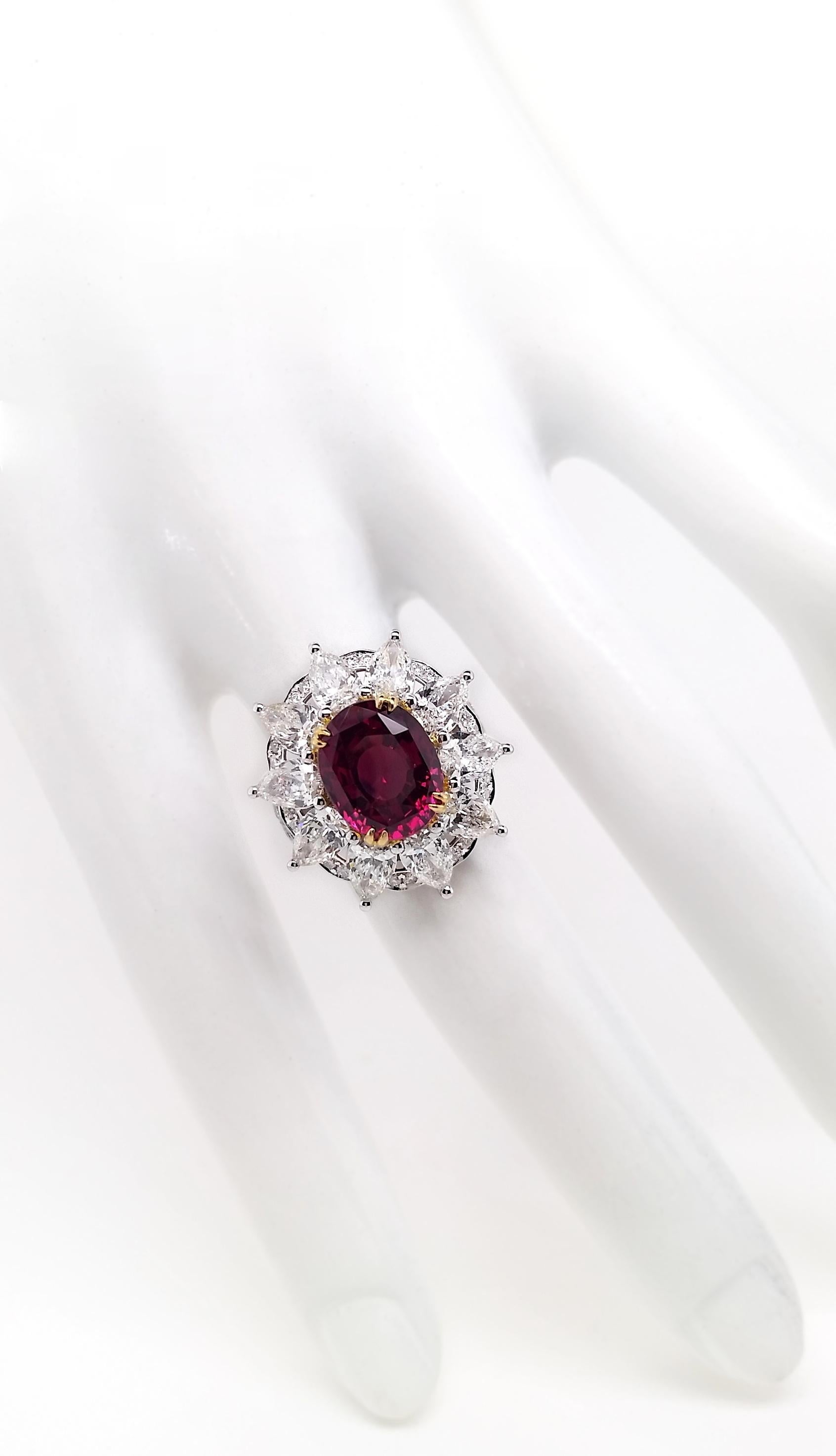 Immerse yourself in luxury with a 6.03-carat Burma ruby, skilfully crafted in an oval mixed-cut. This stunning gem, boasting Fine Color Quality as certified by the IGI,  takes centre stage in a captivating 18K yellow and white gold ring, adorned by