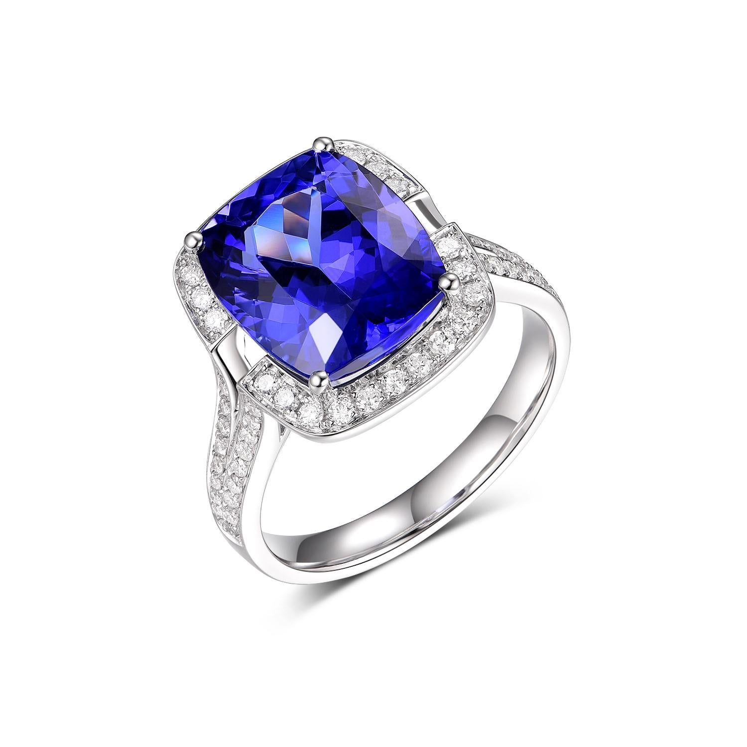 This exquisite ring features a mesmerizing 6.08-carat Tanzanite, known for its striking bluish-violet hue, set in the cool sheen of 18K white gold. The centerpiece gemstone is cut to maximize its deep, rich color and captivating brilliance, making