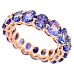 Anillo de eternidad de tanzanita ovalada natural certificada IGI de 6,70 quilates y oro rosa de 14 quilates