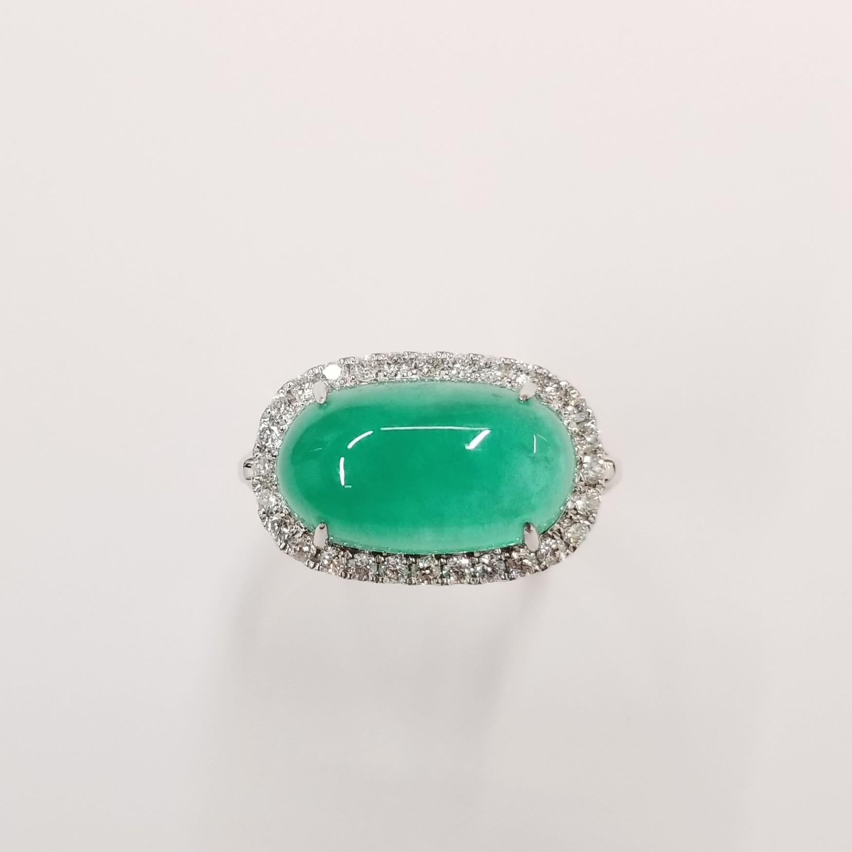 Introducing a stunning masterpiece of craftsmanship, the IGI Certified 7.02 Carat natural emerald in intense bluish green and cabochon long oval shape, accompanied by natural diamonds in a modern oriental style ring. This extraordinary piece,