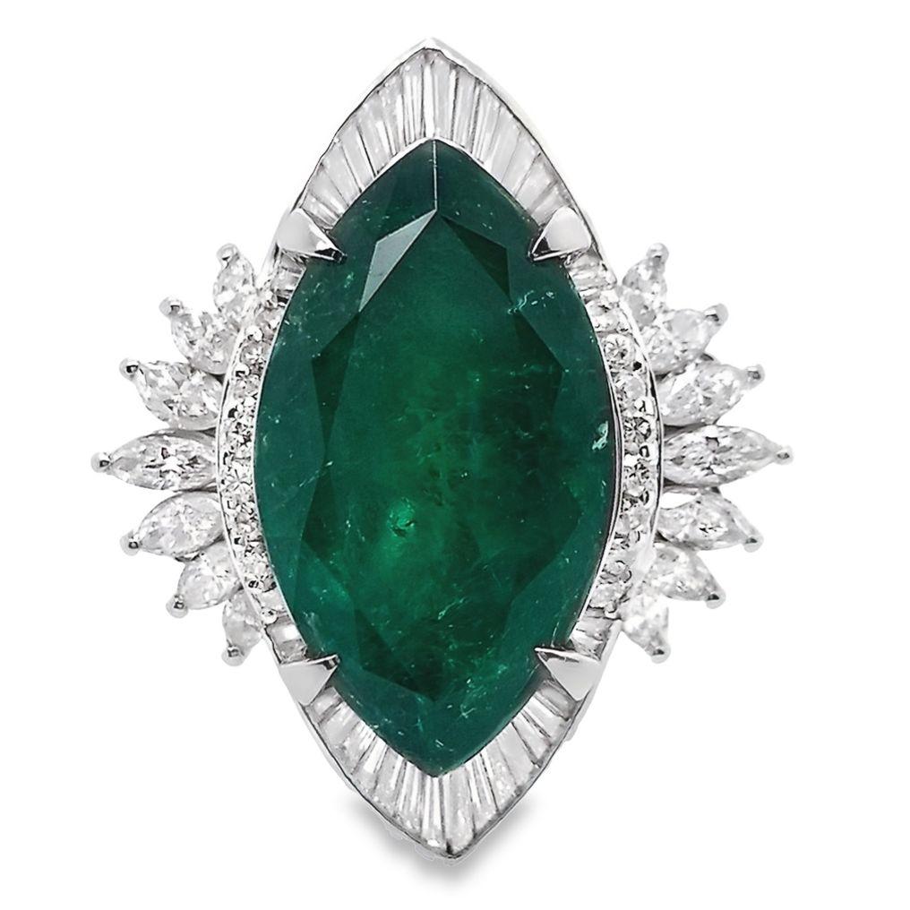 Prepare to be enchanted by the regal allure of this platinum ring, adorned with an 8.53ct Natural Colombia Emerald and 1.49ct Natural Diamonds, verified by IGI (Report: 19J3979923). The mesmerizing marquise modified brilliant-cut emerald,