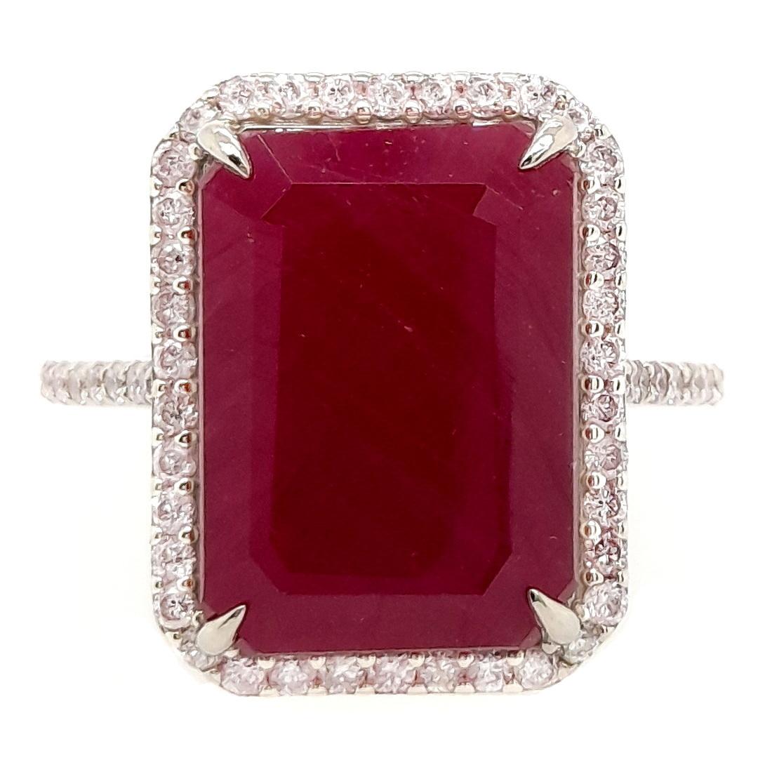 Behold the majestic allure of a 9.74 carat untreated ruby, harmoniously complemented by round brilliant natural diamonds and adorned by a 14K white gold ring. Elevate your collection with this epitome of enduring elegance and opulent beauty, created