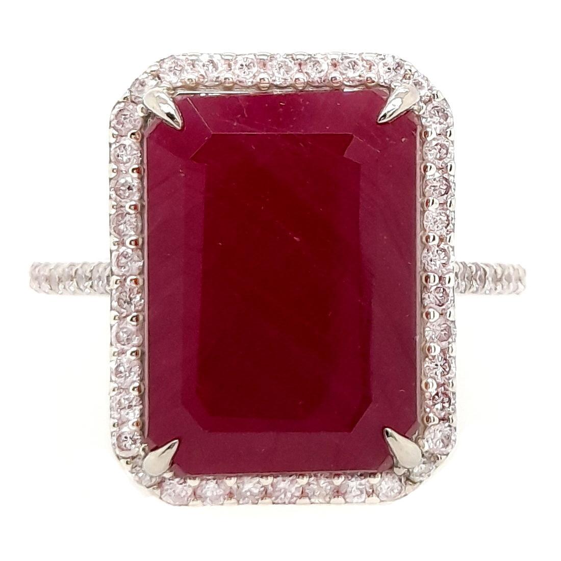 Behold the majestic allure of a 9.74-carat untreated ruby, harmoniously complemented by round brilliant natural diamonds and adorned by a 14K white gold ring. Elevate your collection with this epitome of enduring elegance and opulent beauty, crafted