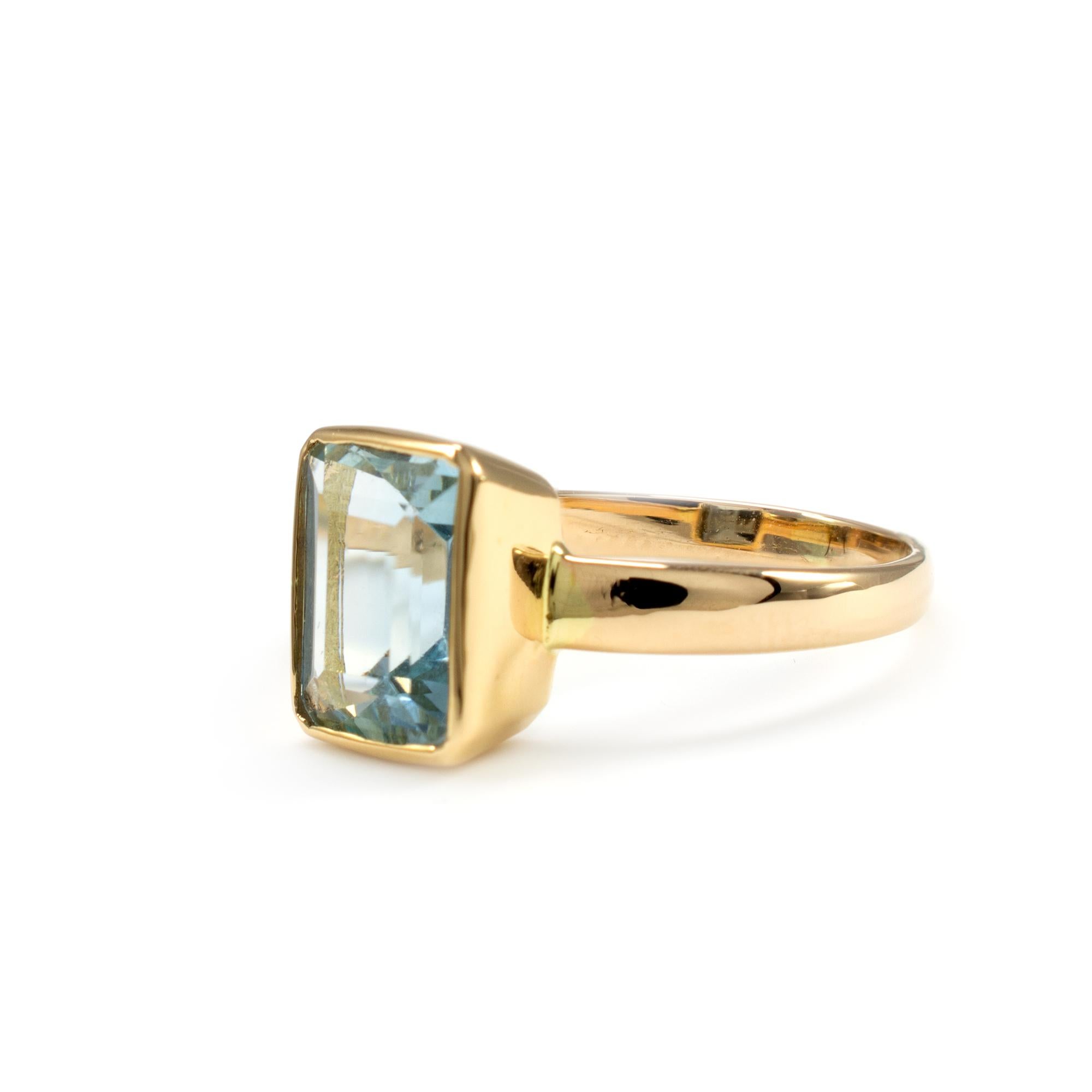 Made to order - This aquamarine ring is crafted in 18 karat yellow gold. The stunning AAA quality octagon square cut natural aquamarine resides in a bezel setting to give a contemporary finish. Presented in fabulous condition with a neat ring box