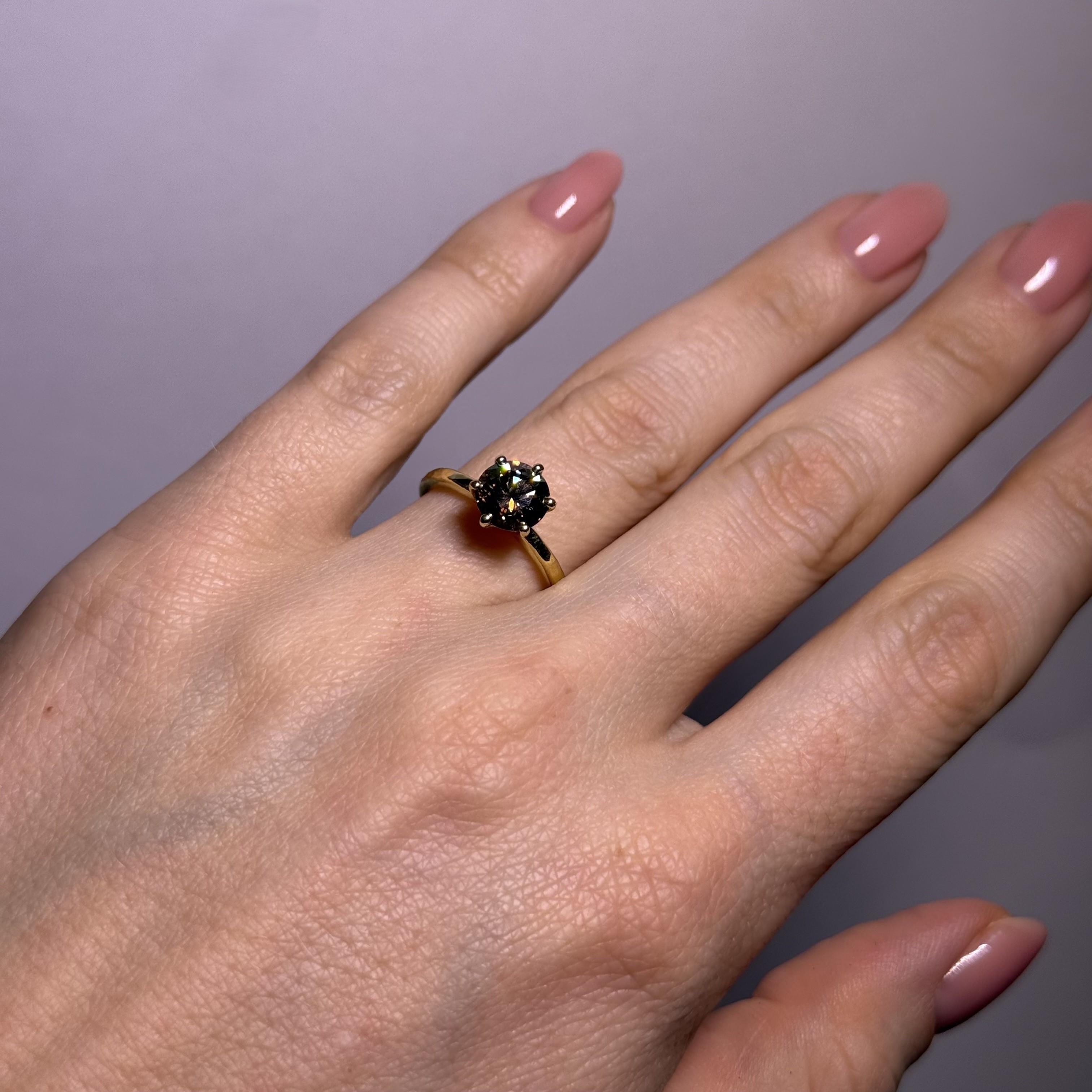 This is not your typical diamond ring. Bold and unforgettable, it features a rare 1.60 carat natural fancy deep brown diamond — a striking alternative to the traditional white stone.

Expertly cut in a round brilliant shape, the diamond exhibits si1