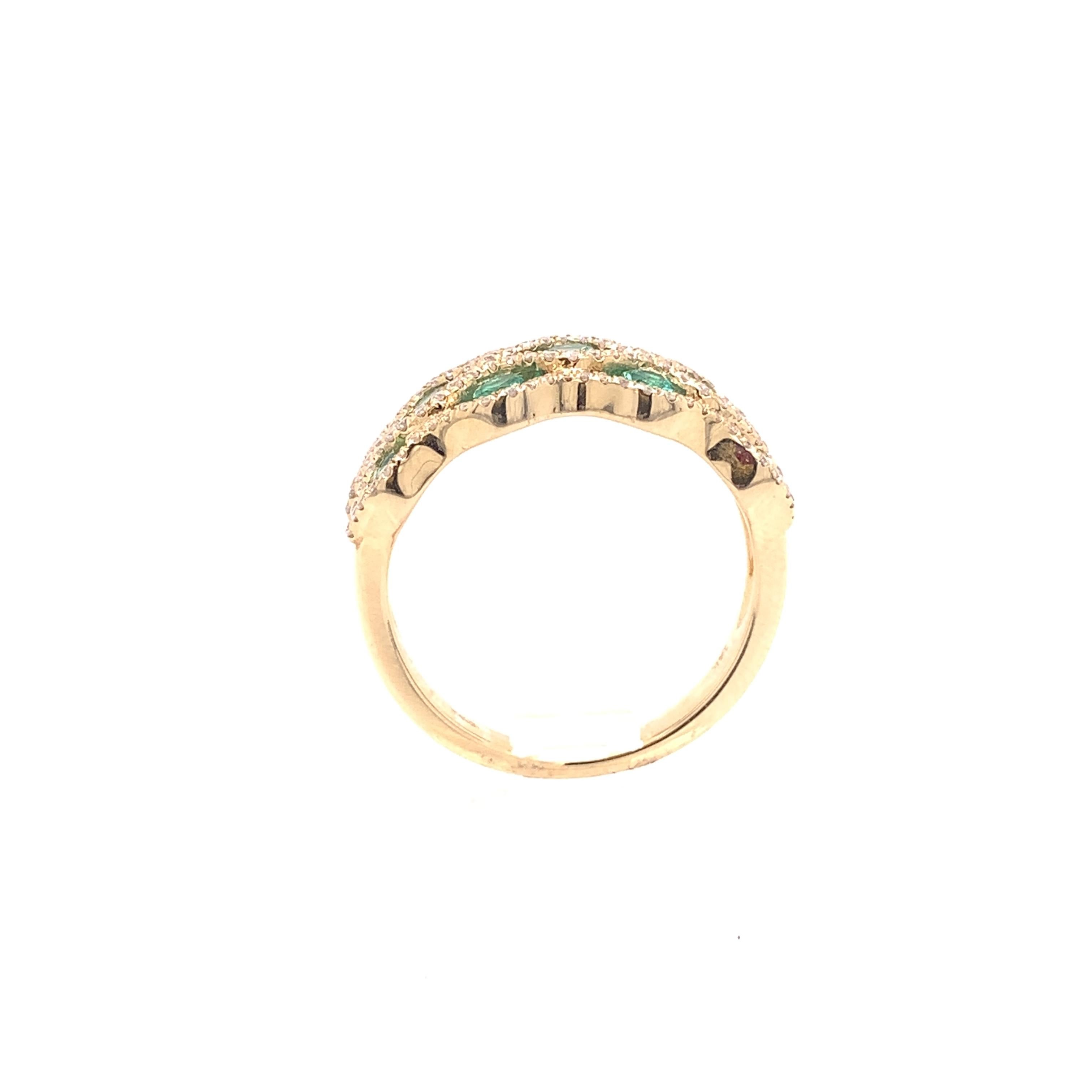 A stunning cocktail ring crafted in 14 karat yellow gold with 11 round natural transparent emerald stones weighing approximately 0.66 carats. The measurements for these stones are 1.80 - 2.40mm. This ring also contains 118 natural round brilliant