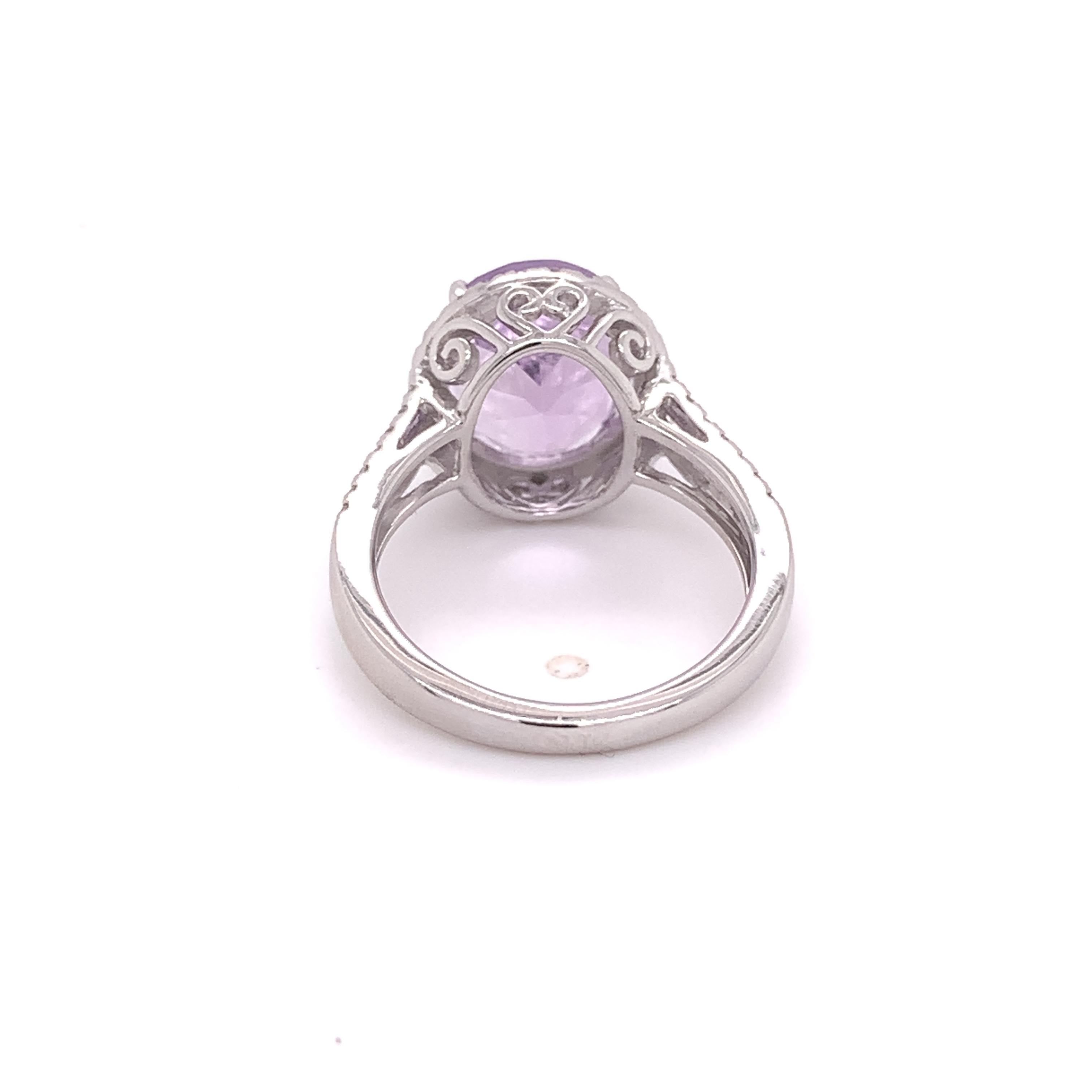 This ring features a lovely natural 4.50 carat Amethyst stone measuring 2.00 x 10.00 x 6.50mm. This ring has a shimmering halo and a split shank set with 54 natural round brilliant diamonds totaling approximately 0.54 carats, H-I color, and I1