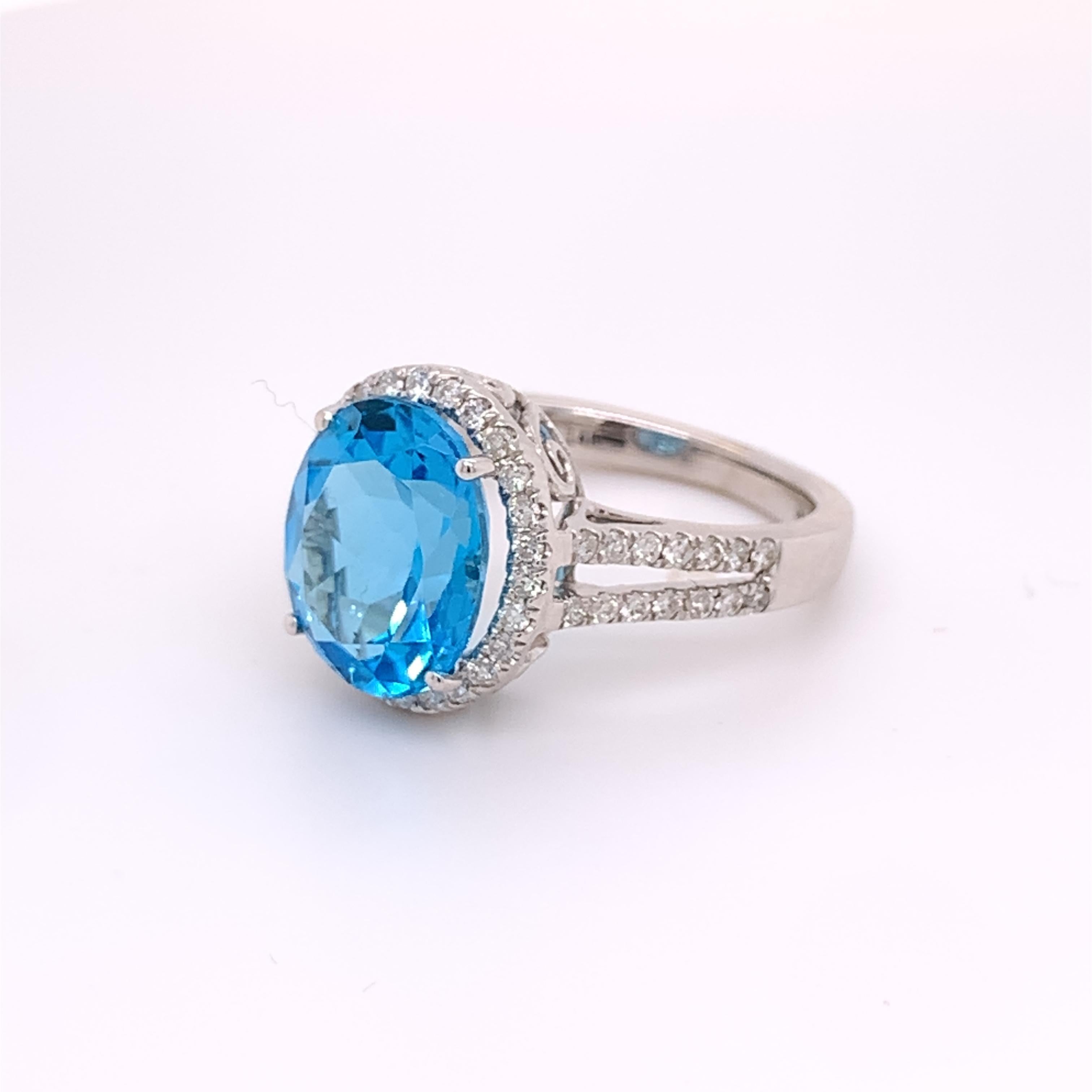 Modern IGI Certified Oval Blue Topaz and Diamond 14k White Gold Halo Ring For Sale