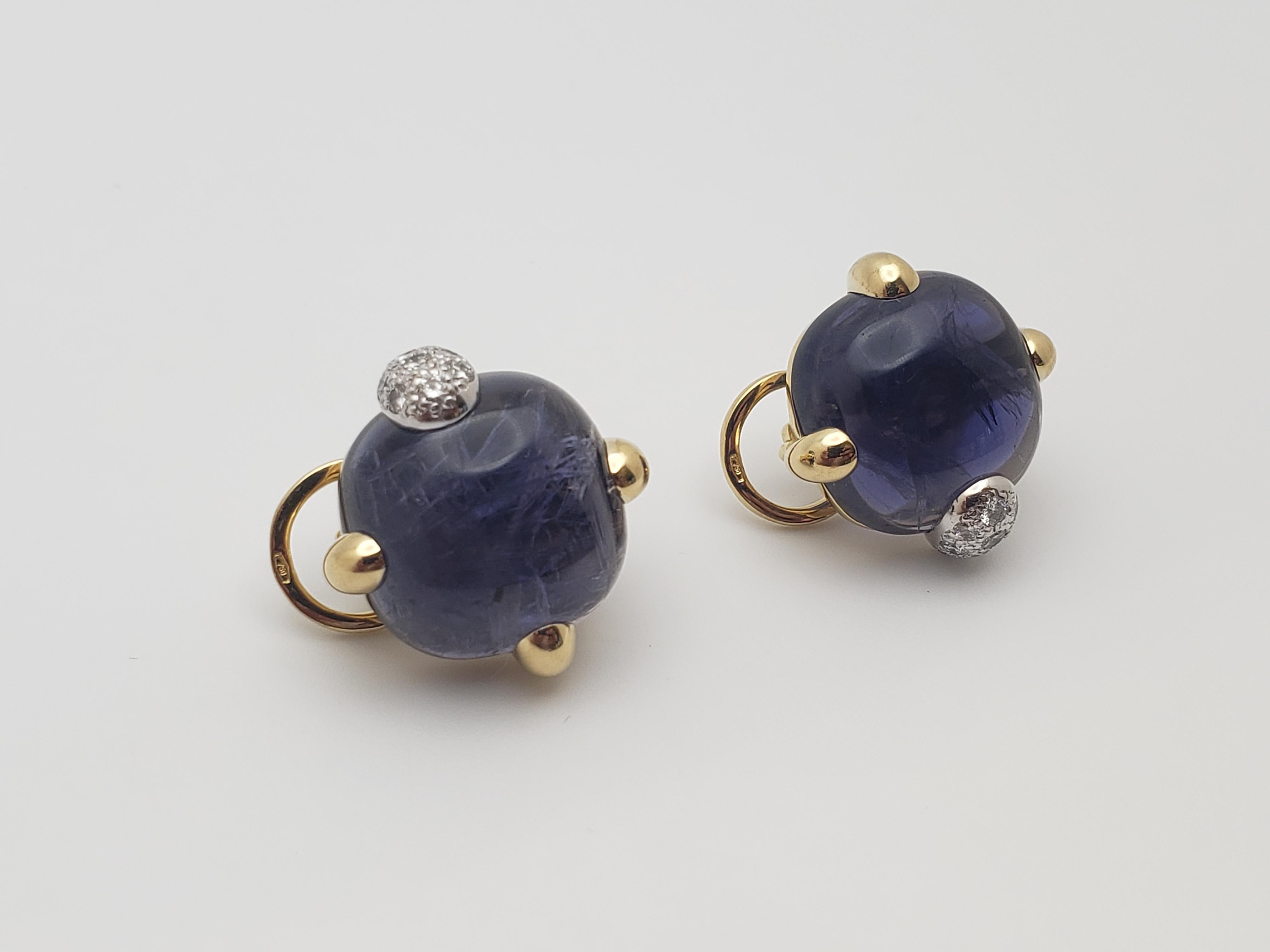 Une paire originale de boucles d'oreilles Pomellato en or jaune et blanc 18 carats, certifiées IGI, composées d'iolite et de diamants. Au centre, deux iolites naturelles en forme de coussin et taillées en cabochon, d'un violet profond, mesurant au