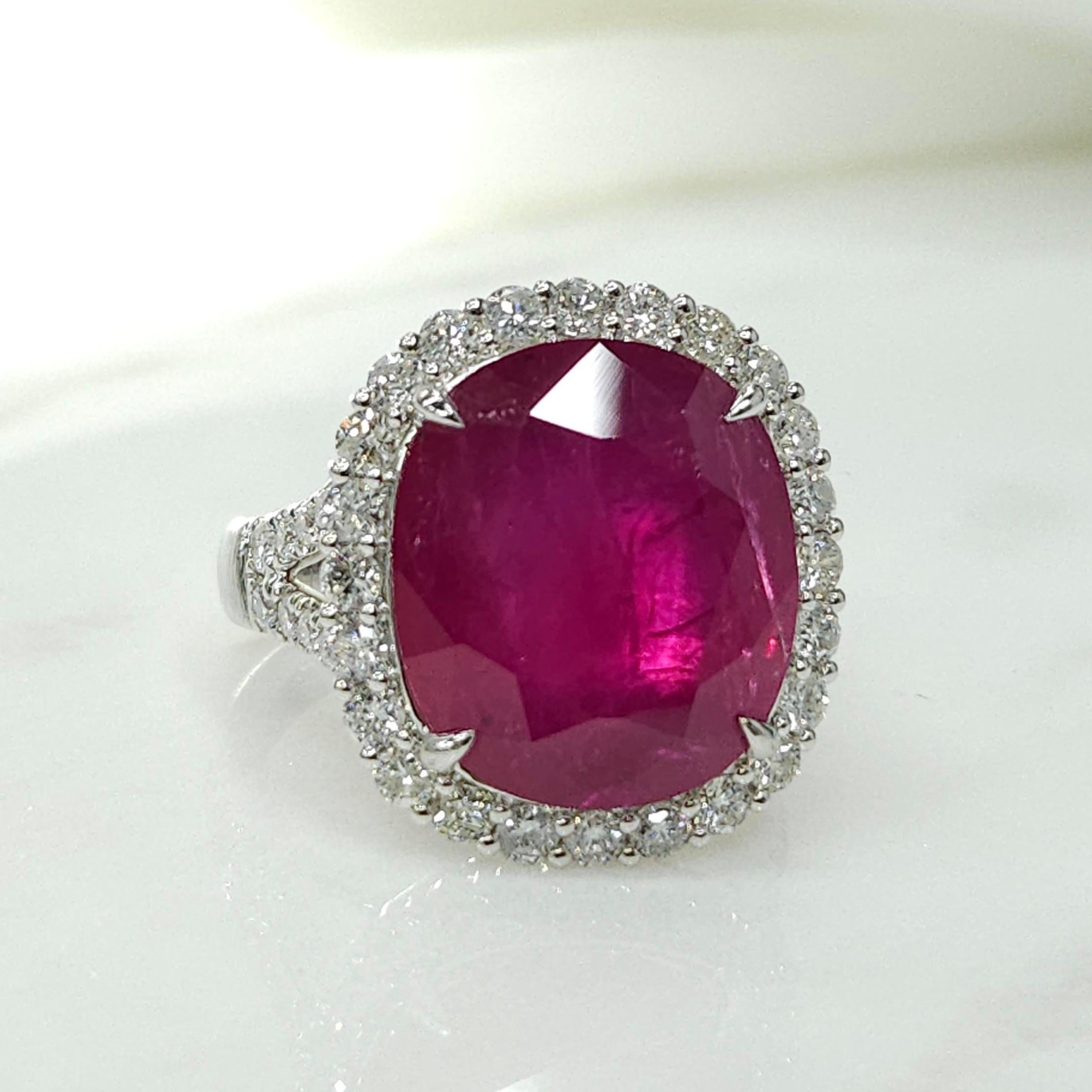 Presenting a truly mesmerizing piece, behold the IGI Certified rare  11.96 Carat Ruby Ring in intense red color, boasting a cushion shape that is sure to captivate any admirer. Set in 18K white gold, this modern-style ring is adorned with the finest