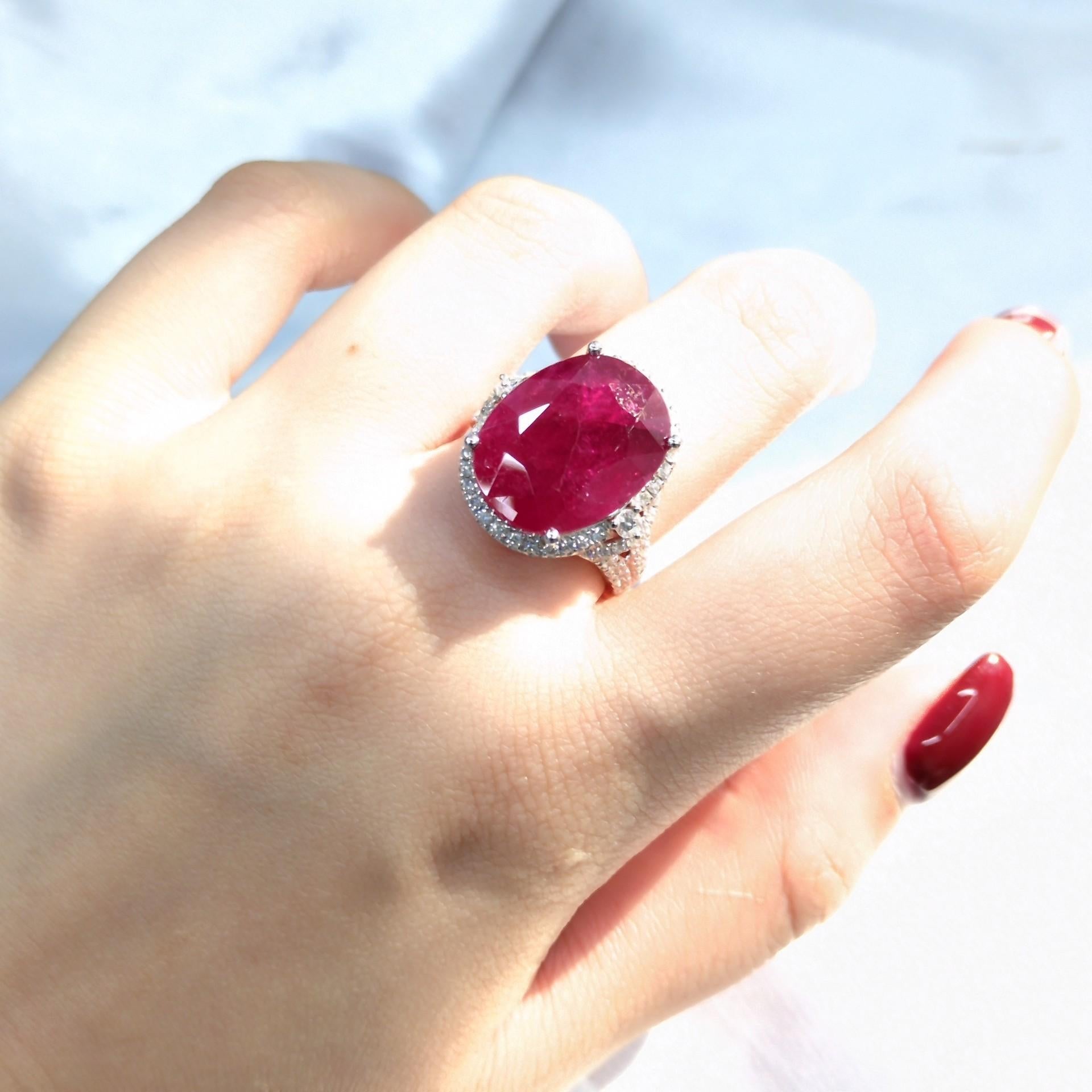 Introducing a truly extraordinary piece of jewelry, the IGI Certified 14.13 Carat Burma Ruby and Diamond Halo Ring. This ring is a testament to the unparalleled beauty and exceptional rarity of its centerpiece, a breathtaking 14.13 carat Burma