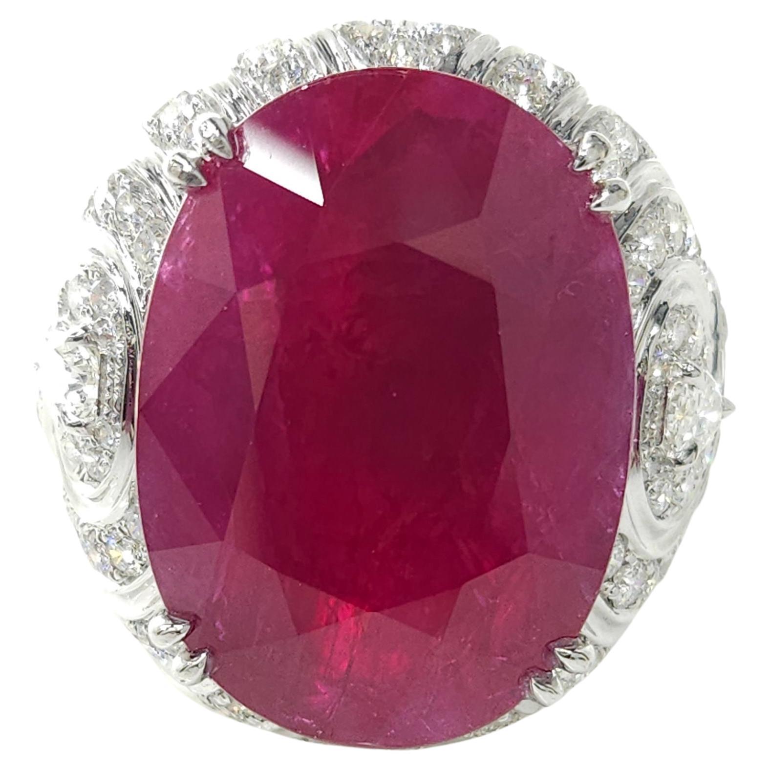 Behold the magnificence of this IGI certified 25.49ct Ruby & 3ct Natural Diamonds Ring in 18K White Gold, a true embodiment of luxury and sophistication. This exquisite piece of jewelry is a masterpiece crafted to showcase the unparalleled beauty of