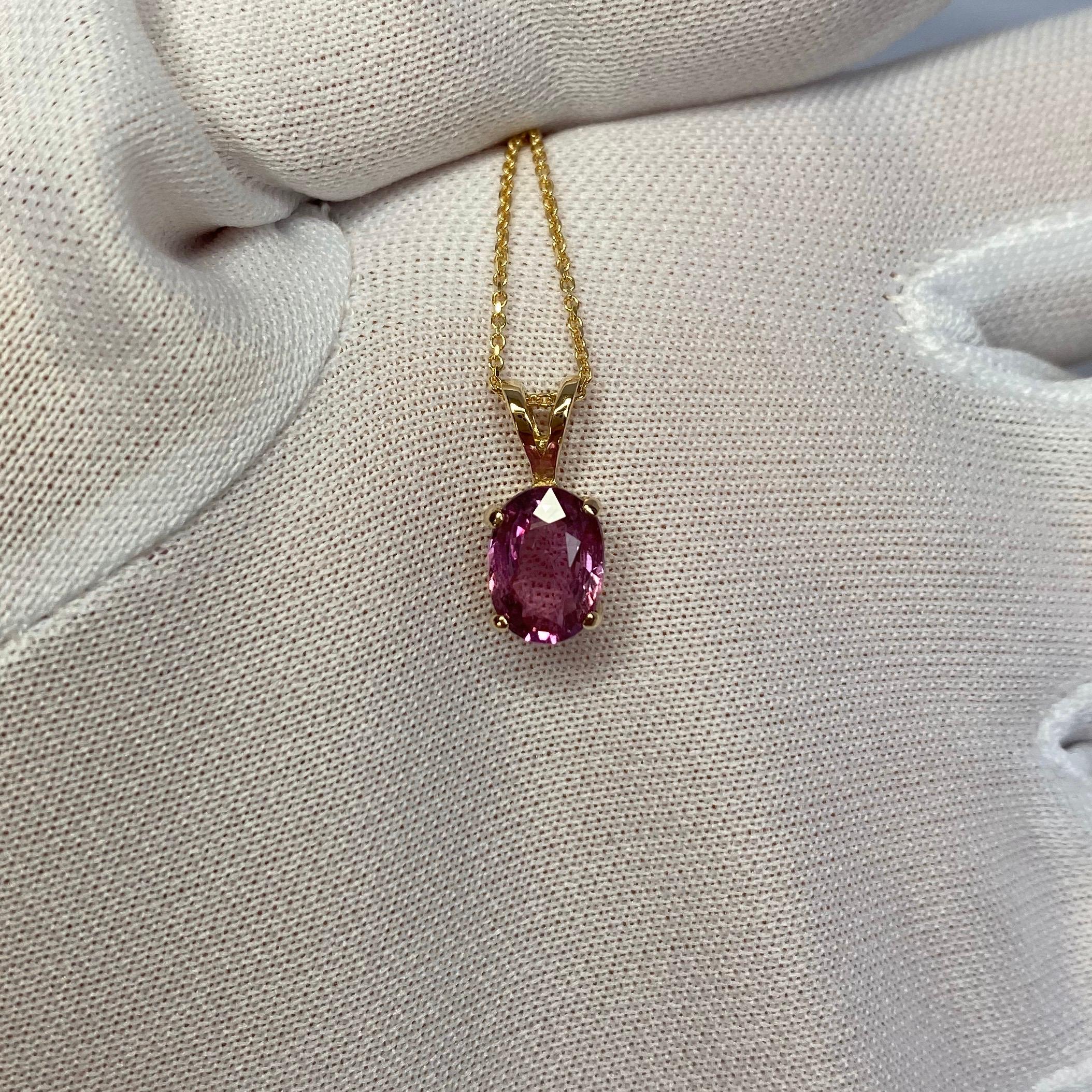 Natural untreated purplish pink sapphire solitaire pendant.
Beautiful oval cut Sapphire. Set in a fine 14k yellow gold pendant setting.

1.61 carat stone with a bright purplish pink colour and very good clarity. Some small natural inclusions visible