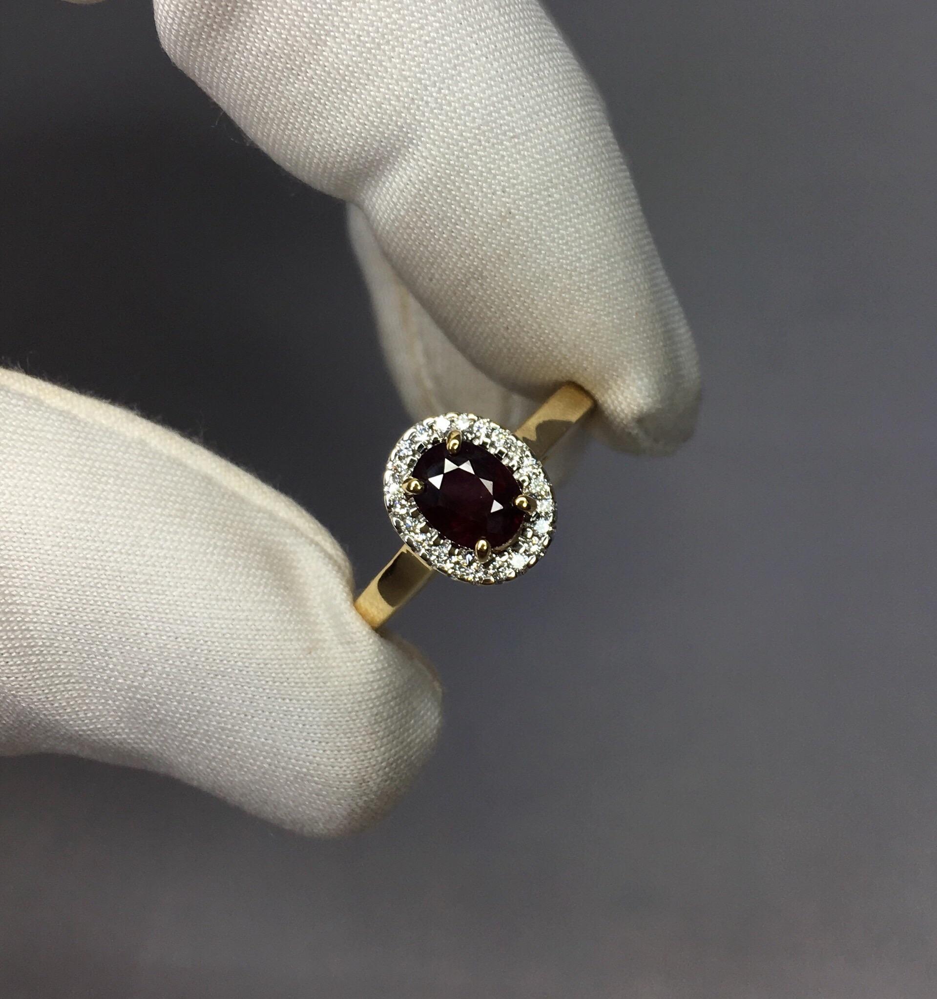 Stunning deep red untreated ruby set in a fine 18k yellow gold diamond halo ring. 

0.84 carat centre ruby with a beautiful deep purplish red colour.
Fully certified by IGI Antwerp confirming stone as untreated and from Madagascar.

Some inclusions