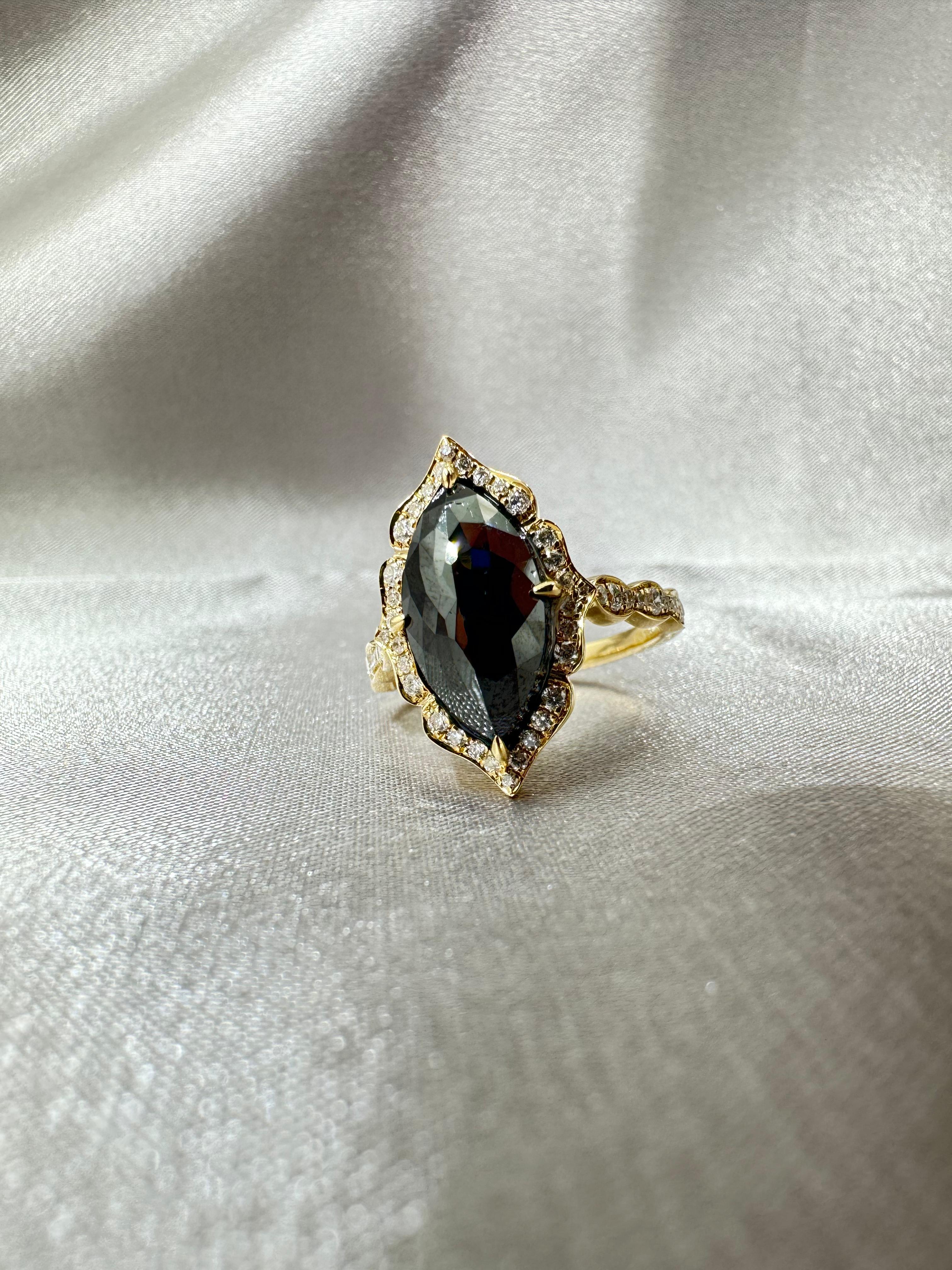 Indulge in the unparalleled beauty of this 14K yellow gold ring, boasting an IGI certified 3.63 carat black diamond. This majestic centerpiece captivates with its profound depth and intriguing allure, making it an instant symbol of