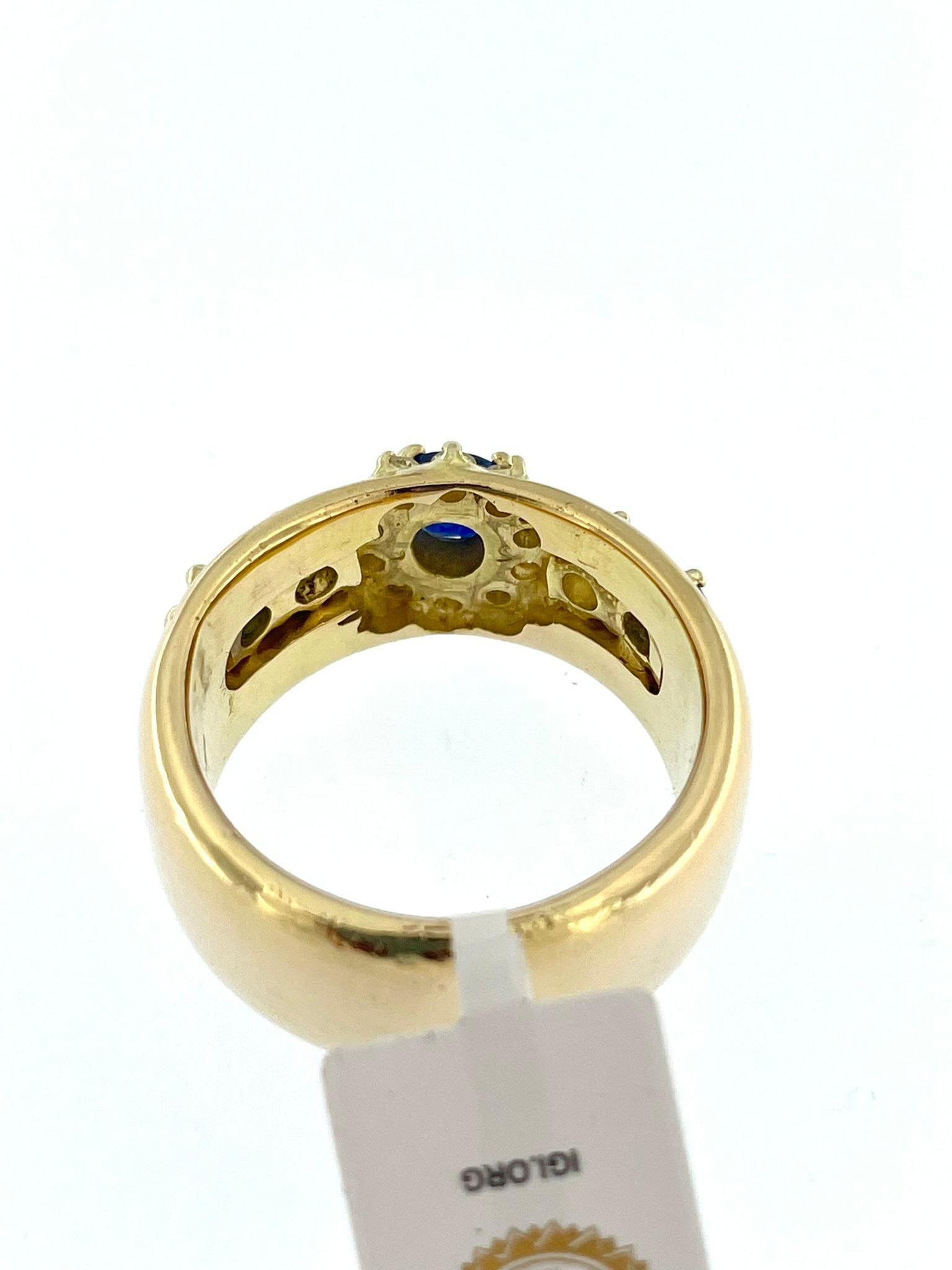 This IGI Certified Yellow Gold Fashion Band Ring is a striking and glamorous accessory that exudes sophistication and style. Crafted in luxurious 18kt yellow gold, this ring features a captivating combination of diamonds and sapphires, making it a