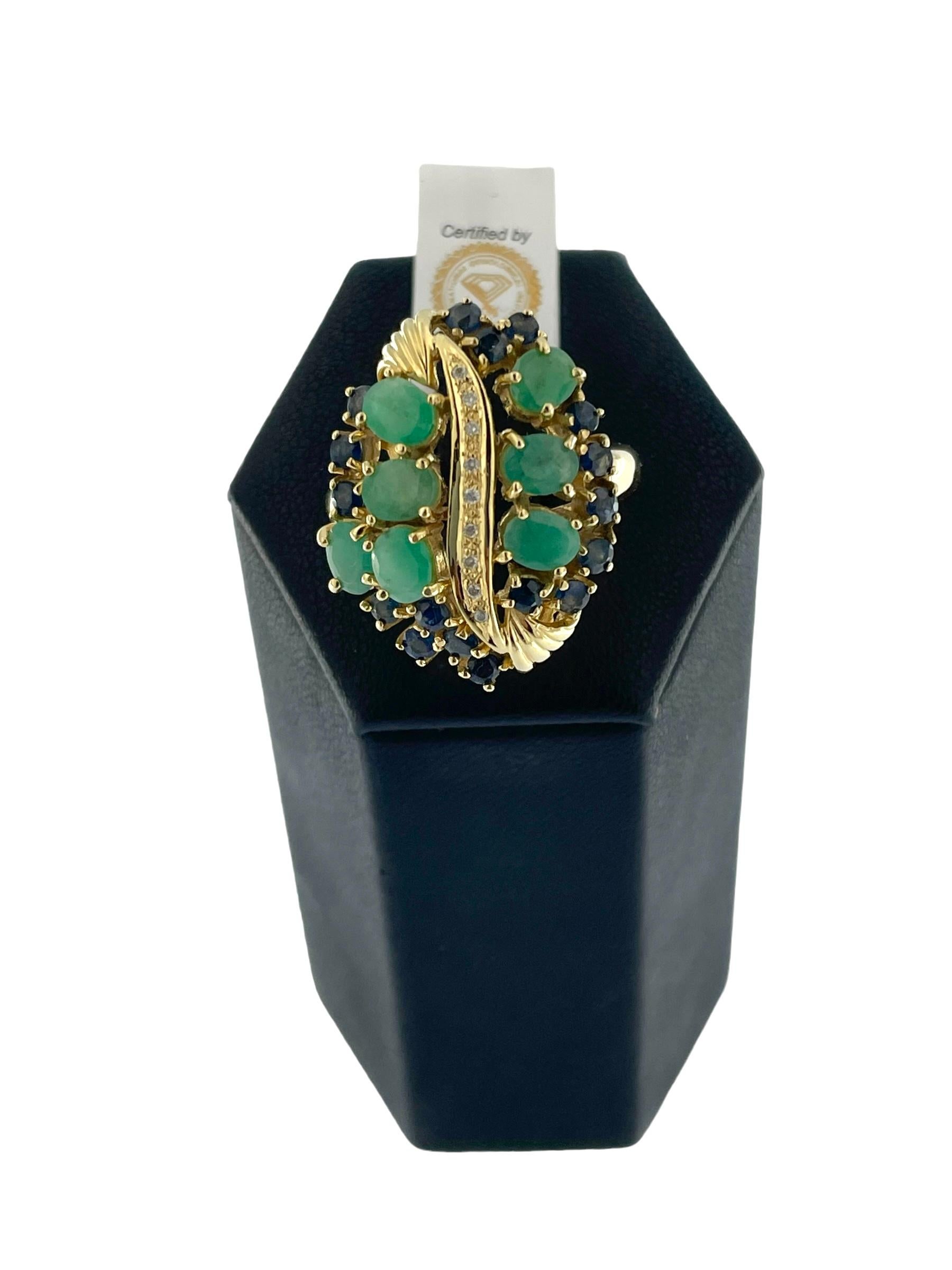 This IGI Certified Yellow Gold Cocktail Ring is a dazzling and luxurious piece of jewelry that combines the timeless beauty of diamonds, sapphires, and emeralds. Crafted in 18kt yellow gold, this ring showcases a perfect blend of retro design with a