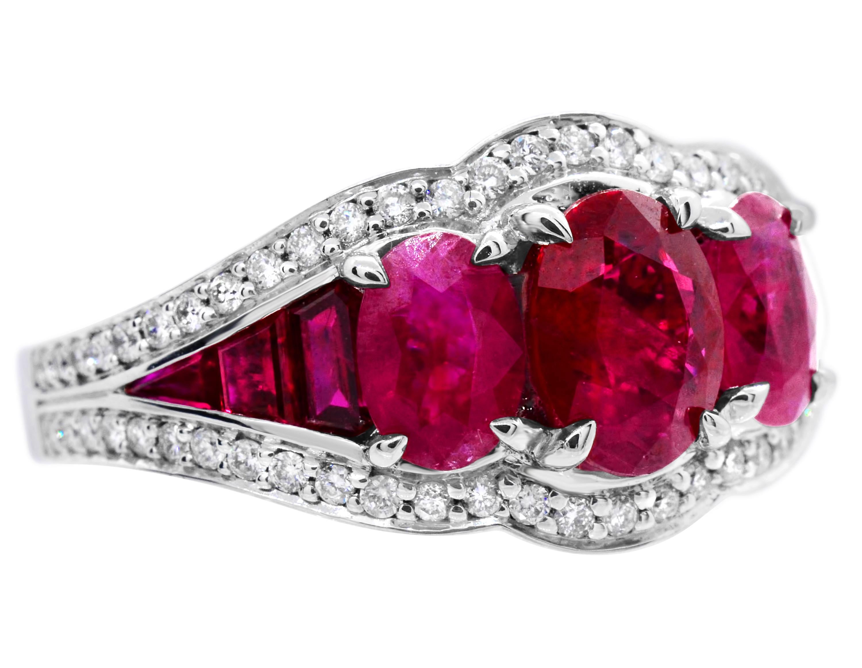 Three-stone 14Karat white gold ruby ring.  This three-stone cocktail ring has a 7 x 5 oval ruby at the center that weighs 1.10 carat.  At each side, there is a 6 x 4 ruby that have a combined total weight of 1.20 carat.  Additionally, on each side