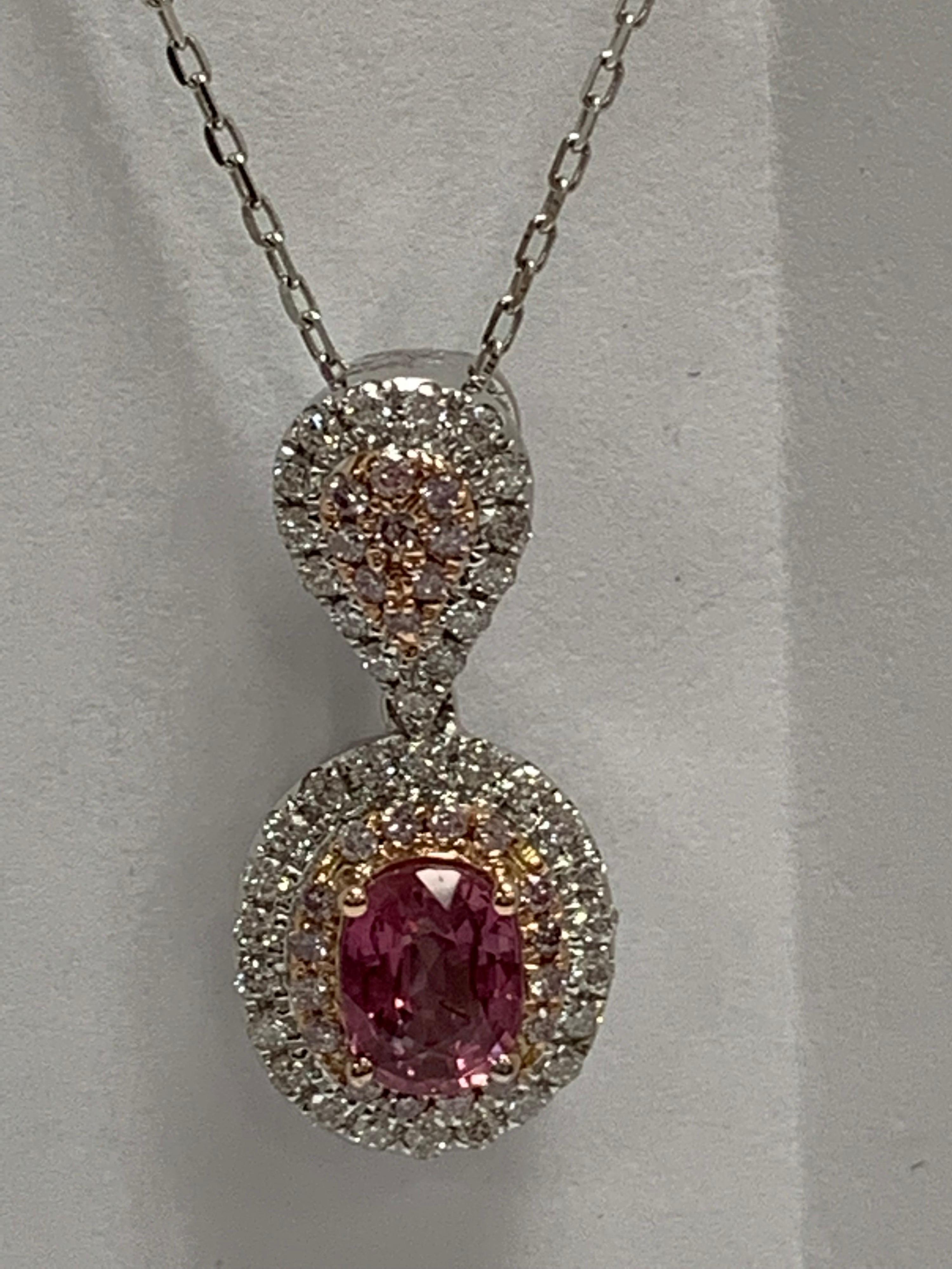 Natural IGL Certified 1.13 Carat Oval Padparadscha Sapphire, 0.18 Carat Natural pink and 0.31 Carat white diamonds set in 14 Karat white gold. The pendant is one of a kind and handcrafted.The pendant include 18 inches chain.