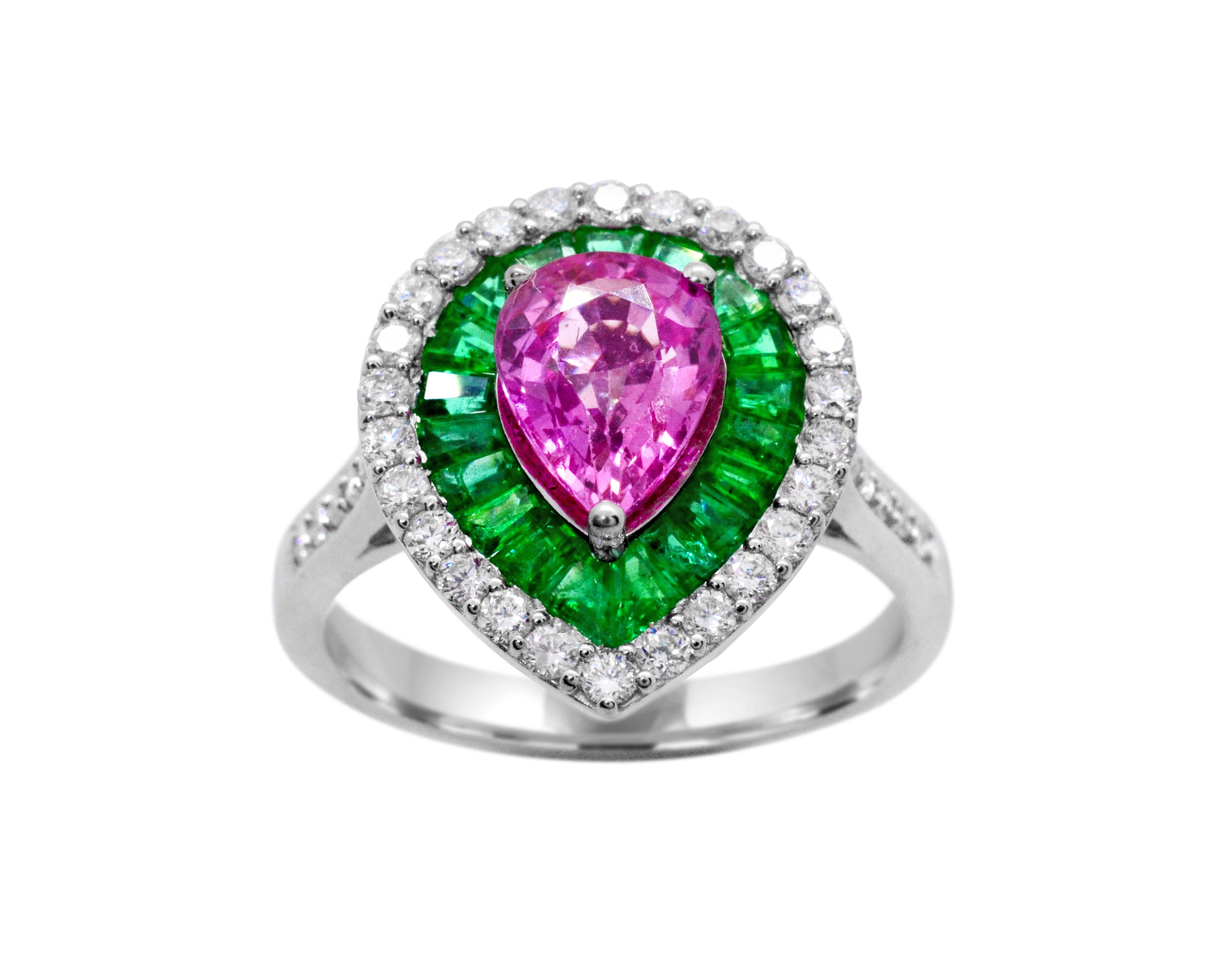 Stunning and vibrant color.  This 1.60 carat pear-shaped Madagascar pink sapphire is framed by 1.55 carat of Zambian baguette Emeralds.  Diamonds of G-I color. Total 0.46 carat weight.  These diamonds halo the center gemstones and continue to run