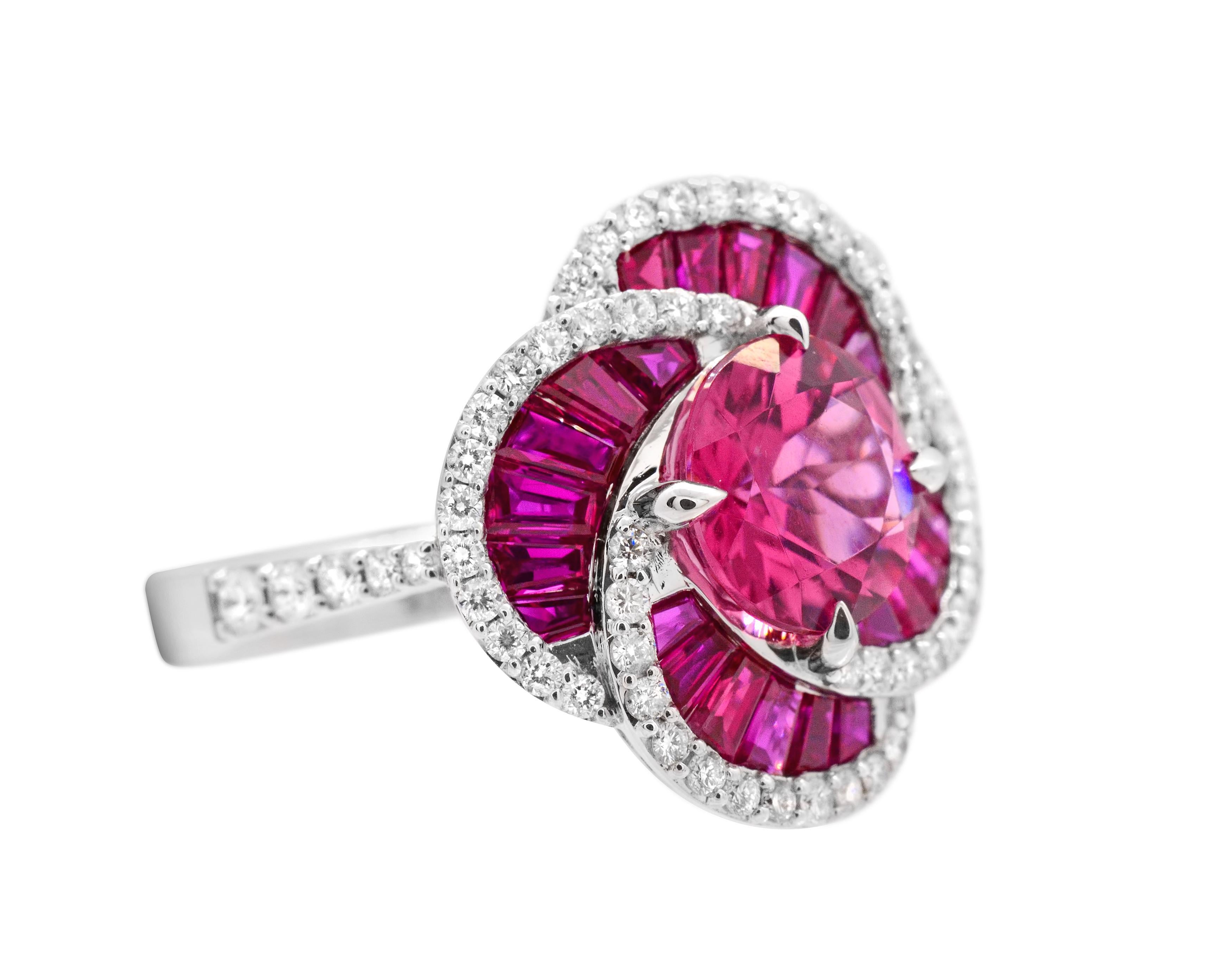 Exceptional colors in a unique silhouette.

A well saturated 1.73 carat pink tourmaline sits at the center of this 14Karat white gold cocktail ring, with encircling tapered baguette rubies that are equally as vibrant.  More than a 0.50 carat of